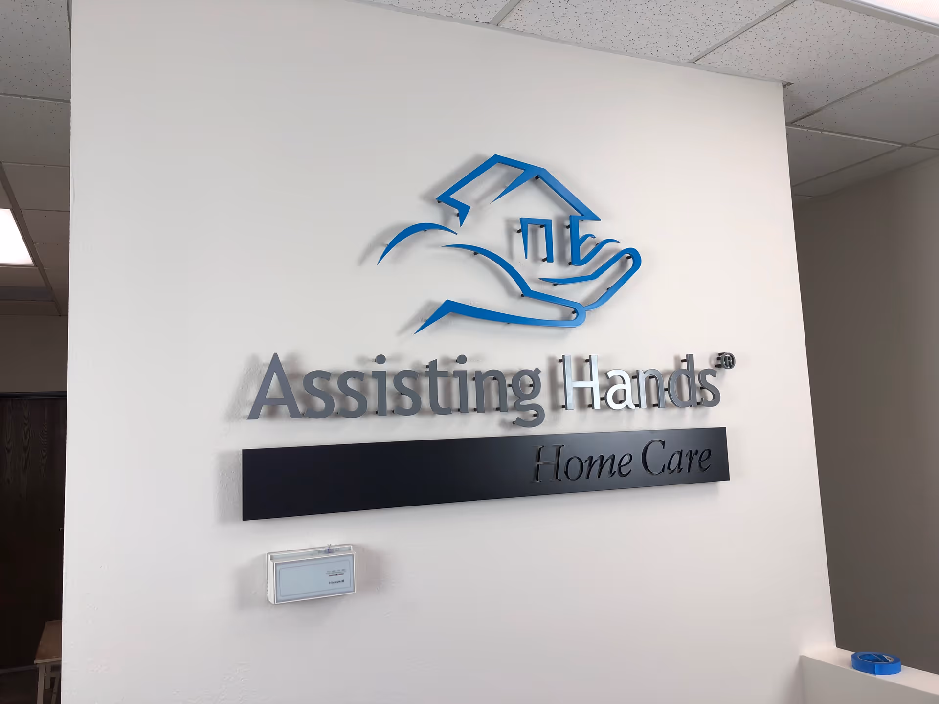 This interior wall features the Assisting Hands Home Care logo sign.