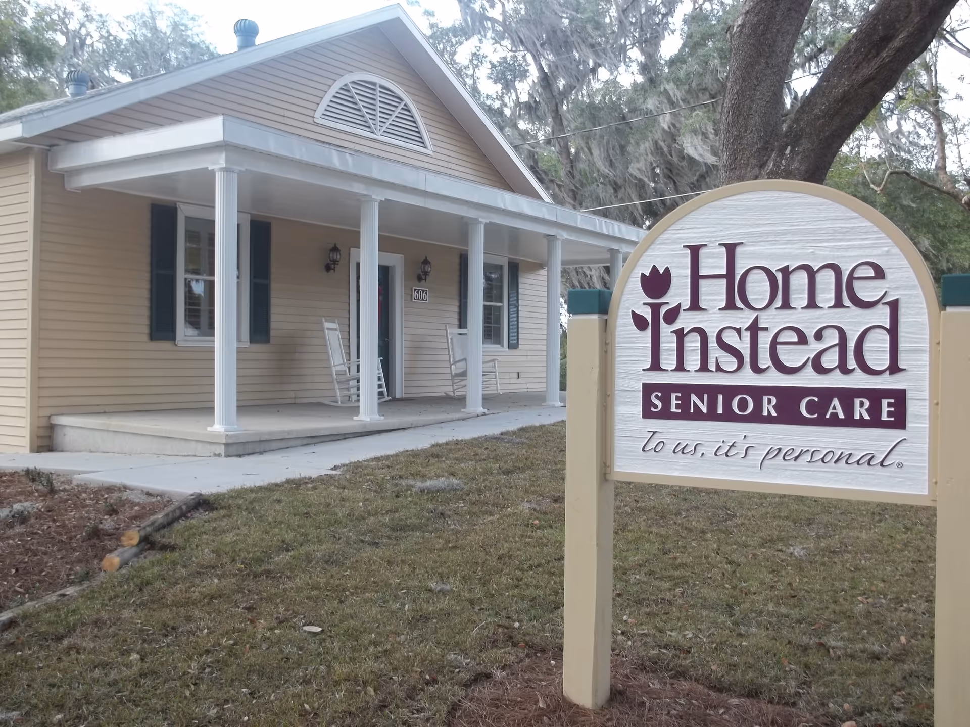 Exterior view of a Home Instead Senior Care facility with a large front sign and porch.