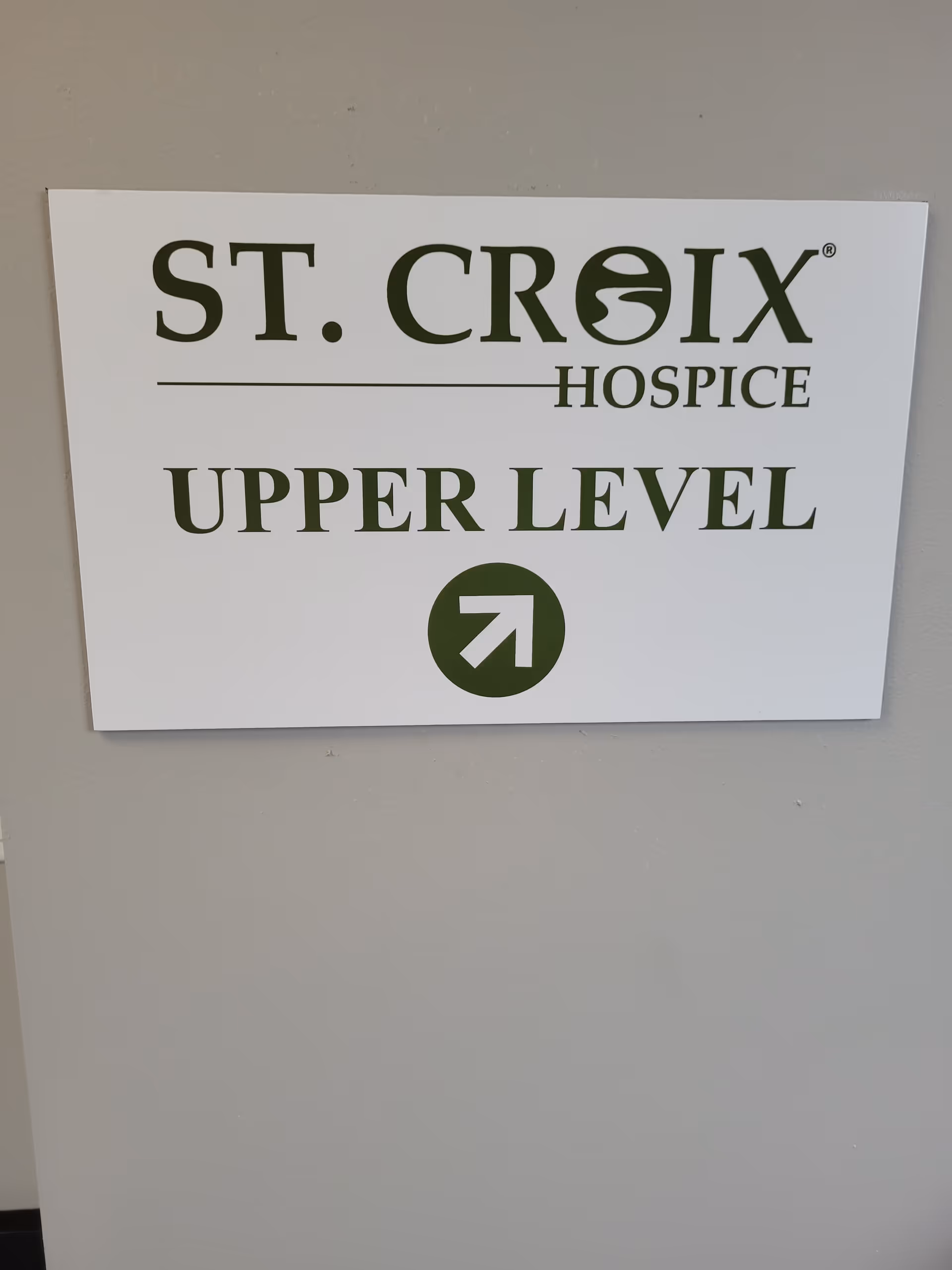 A white interior sign on a wall reads St. Croix Hospice Upper Level.