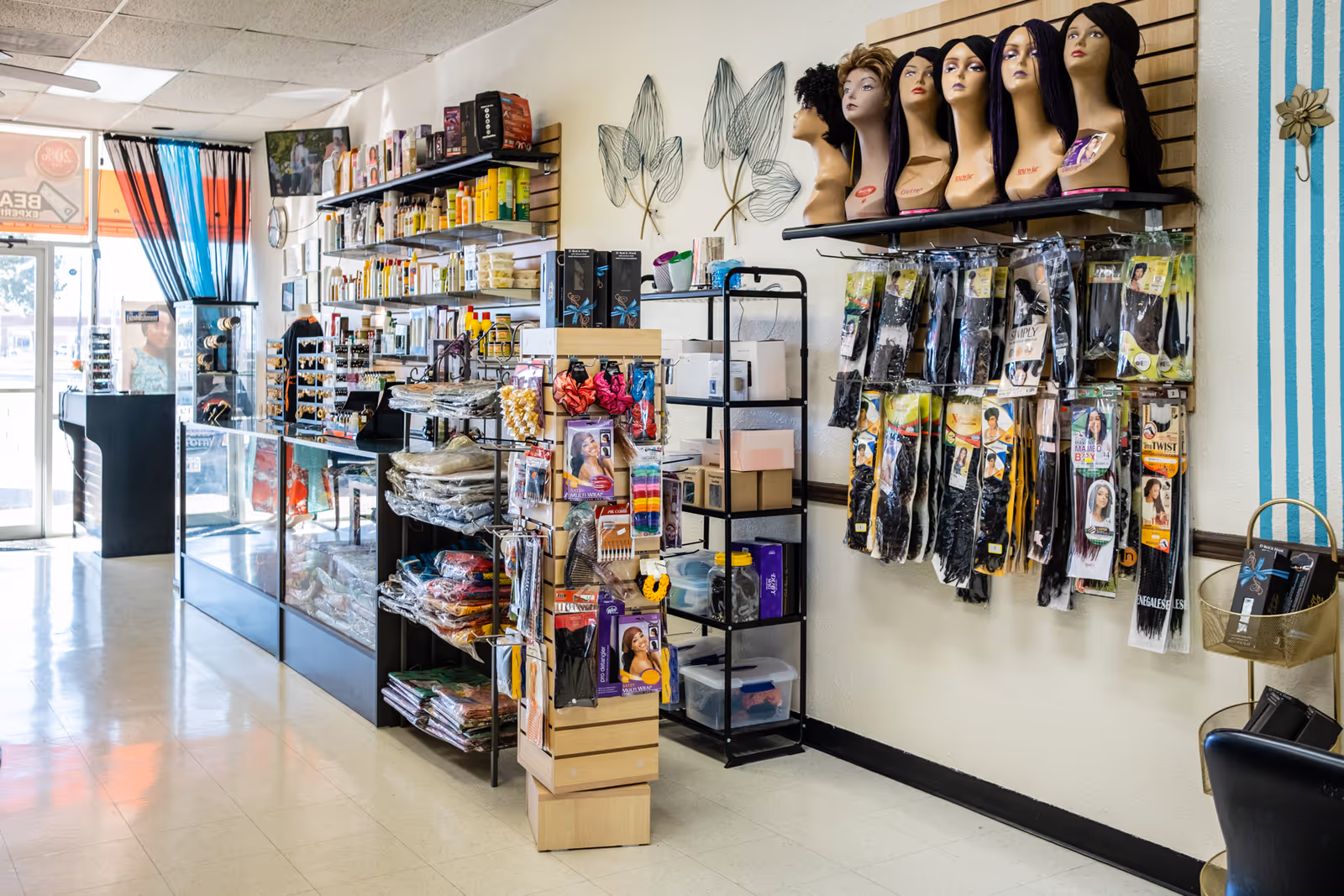 Brightly lit interior of a senior living facility beauty shop with shelves and wig displays