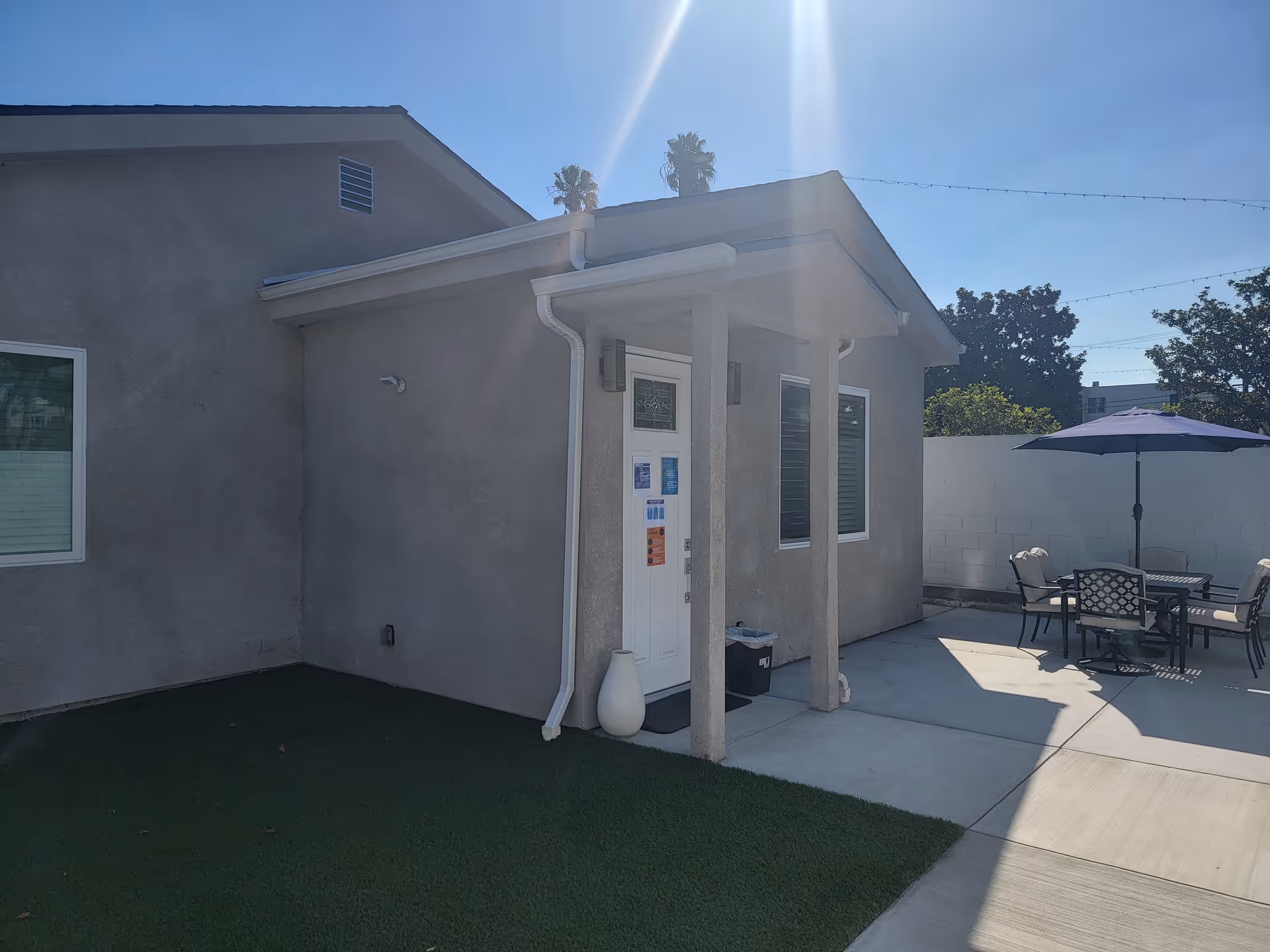 Exterior view of Love Is Us RCFE with a patio dining area and seating.