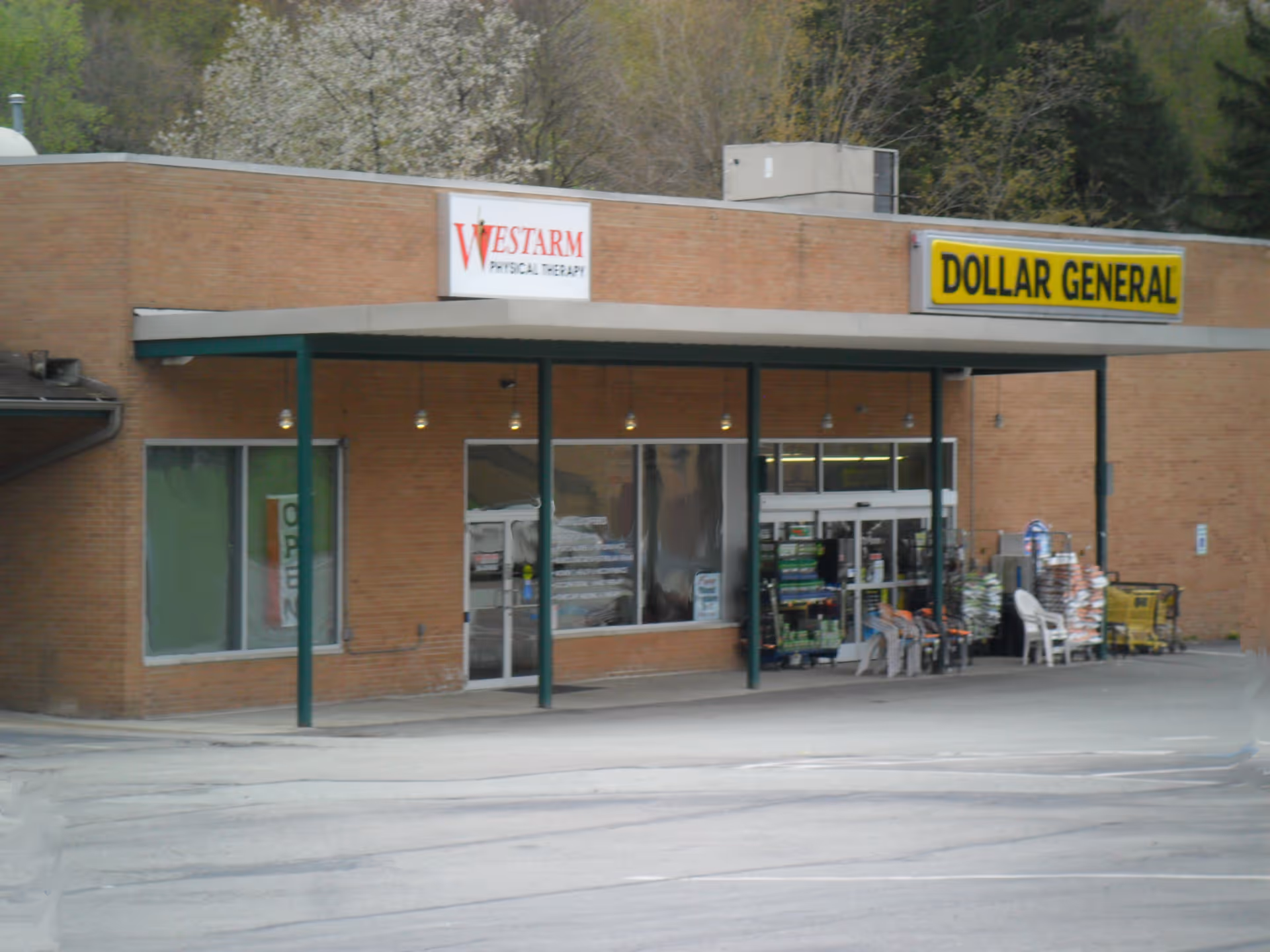 Brick storefront featuring Westarm Physical Therapy and Dollar General signage.