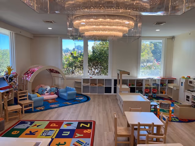 Bright indoor playroom at Attending Angels Home Care & Adult Day Center with toys.