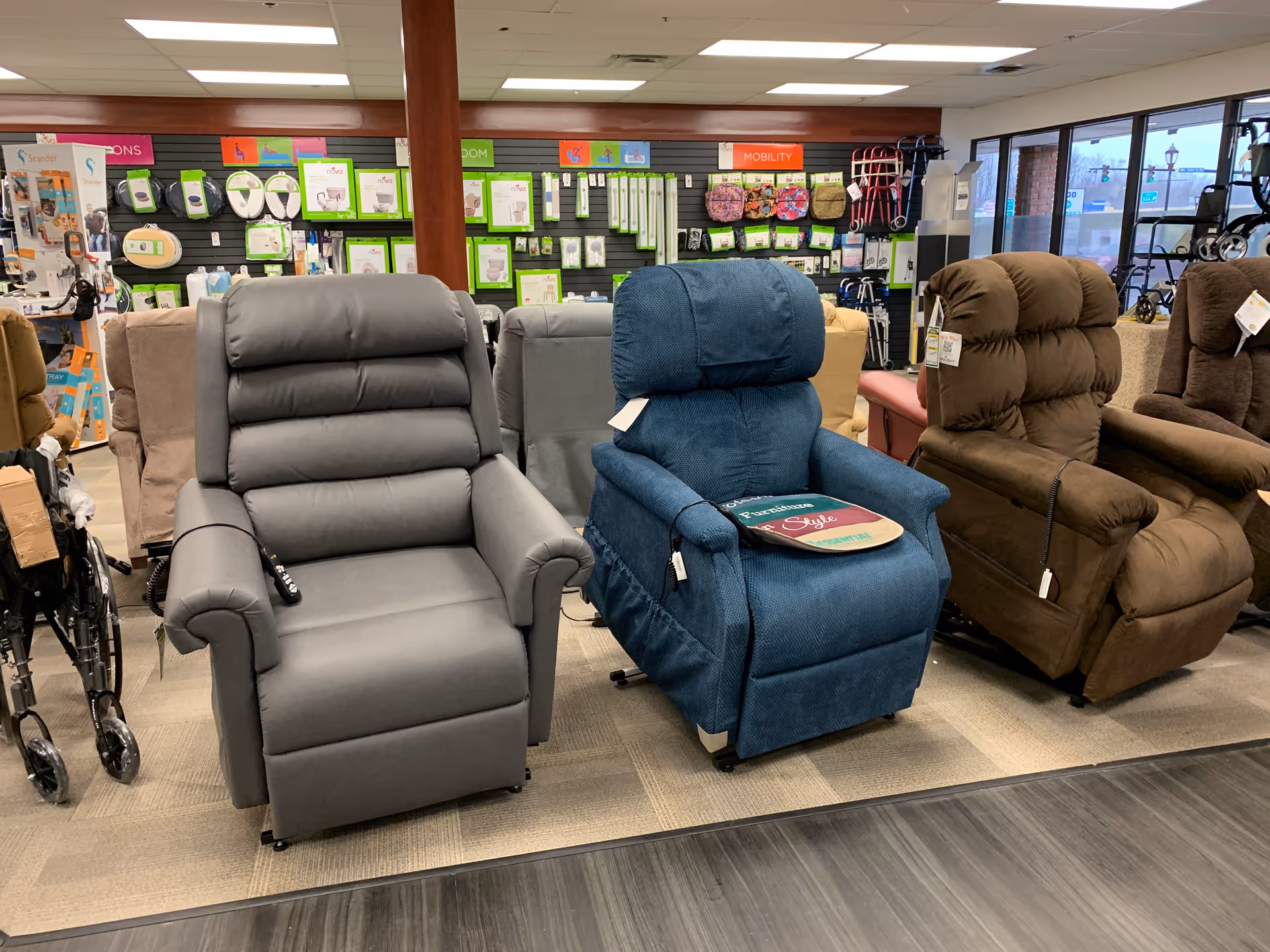 Row of large recliner chairs in a medical supply showroom.