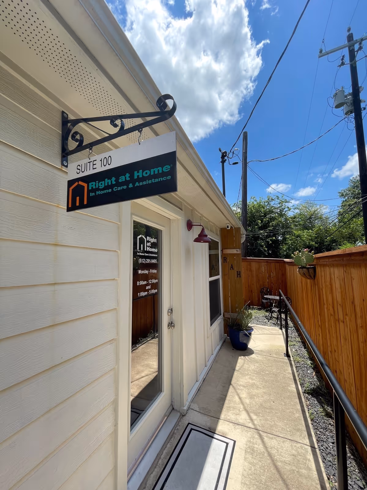 Exterior view of Right at Home entrance with sign and walkway
