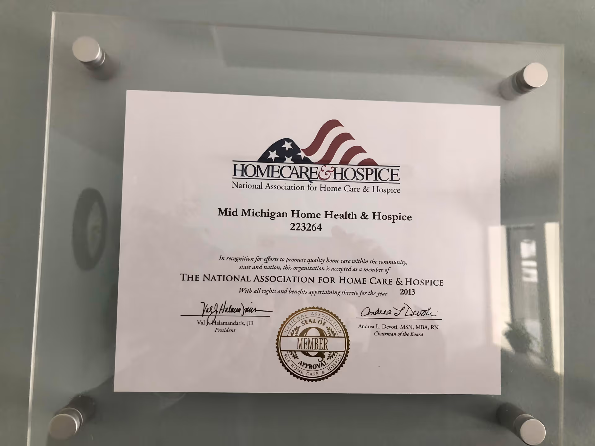 Certificate for Mid Michigan Home Health & Hospice displayed on a glass plaque.