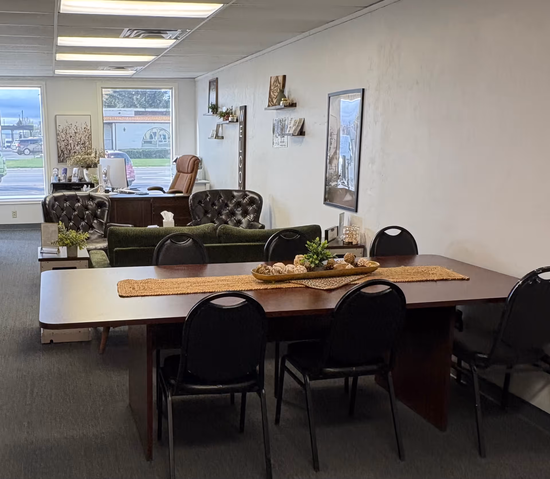 A long dining table with chairs in a senior living facility common area.