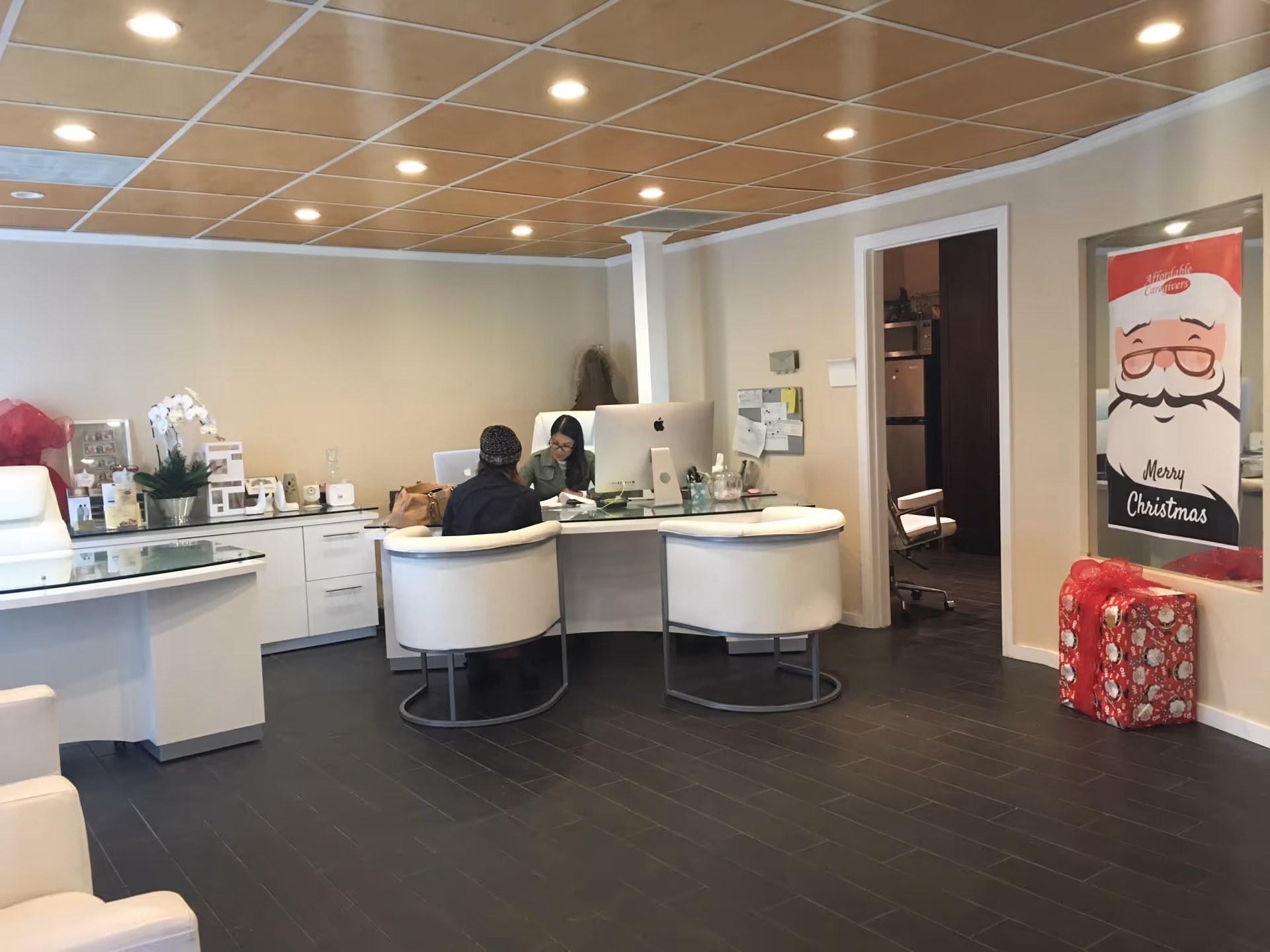 Bright reception area with staff assisting visitors at a curved desk.