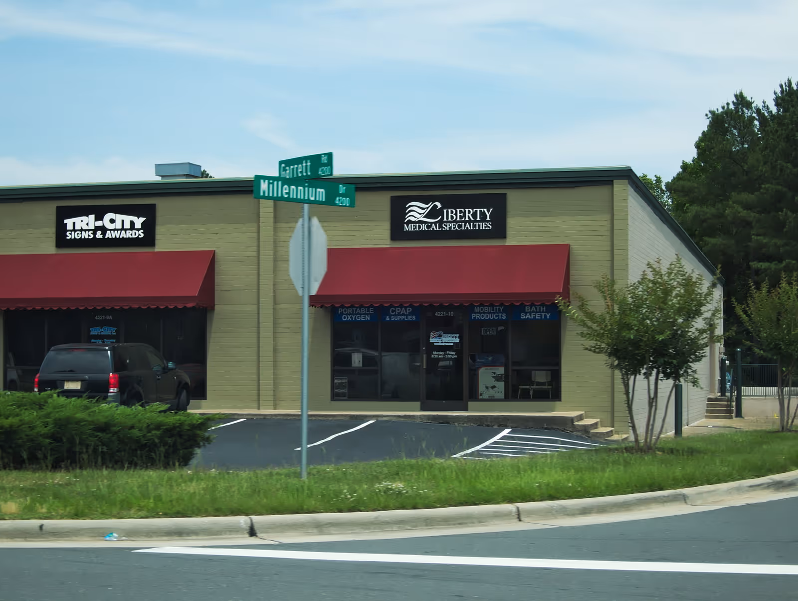 Exterior storefront with Liberty Medical Specialties sign and red awnings.