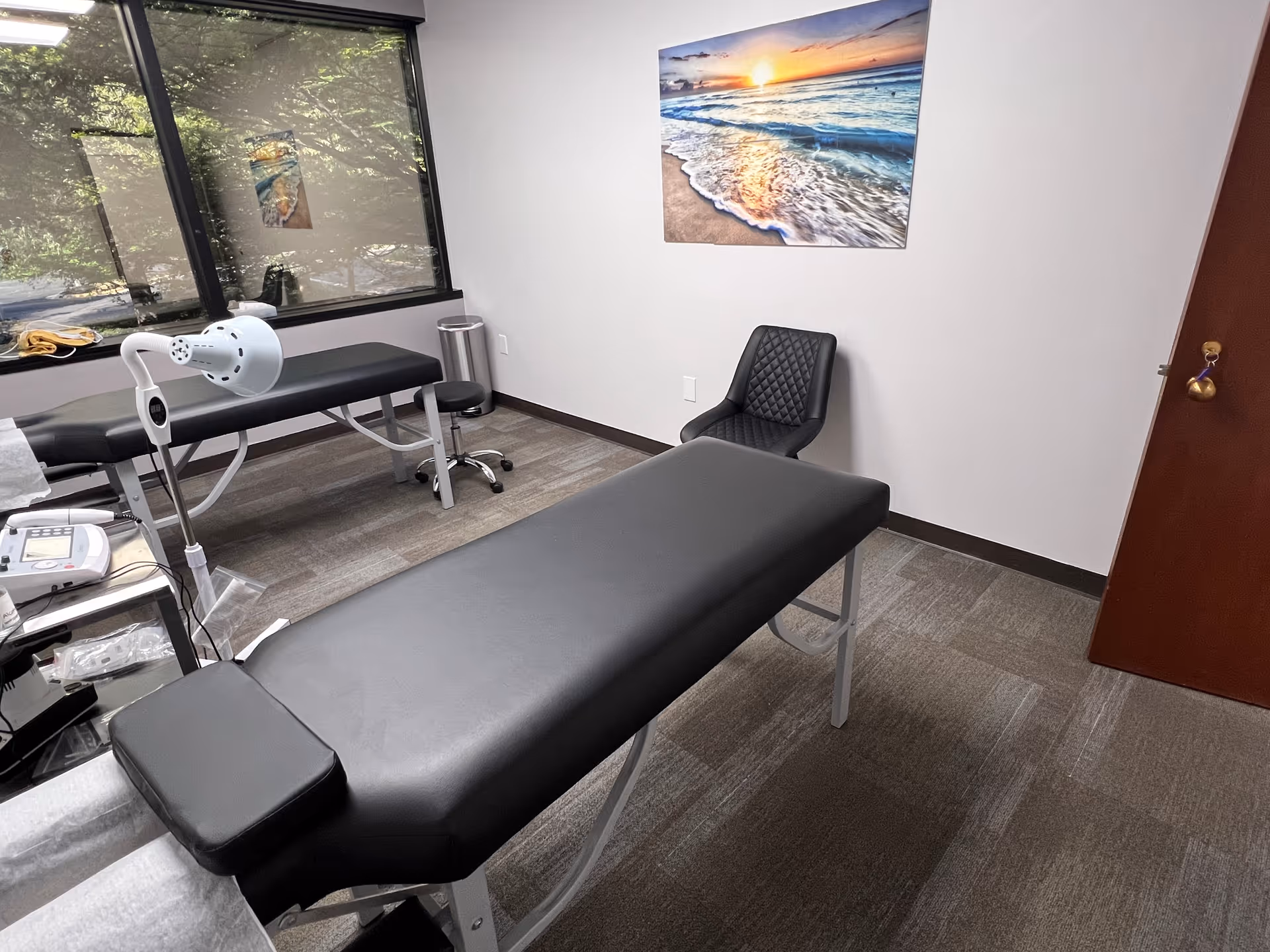 A treatment room in a Project Health Corp facility with an exam table.
