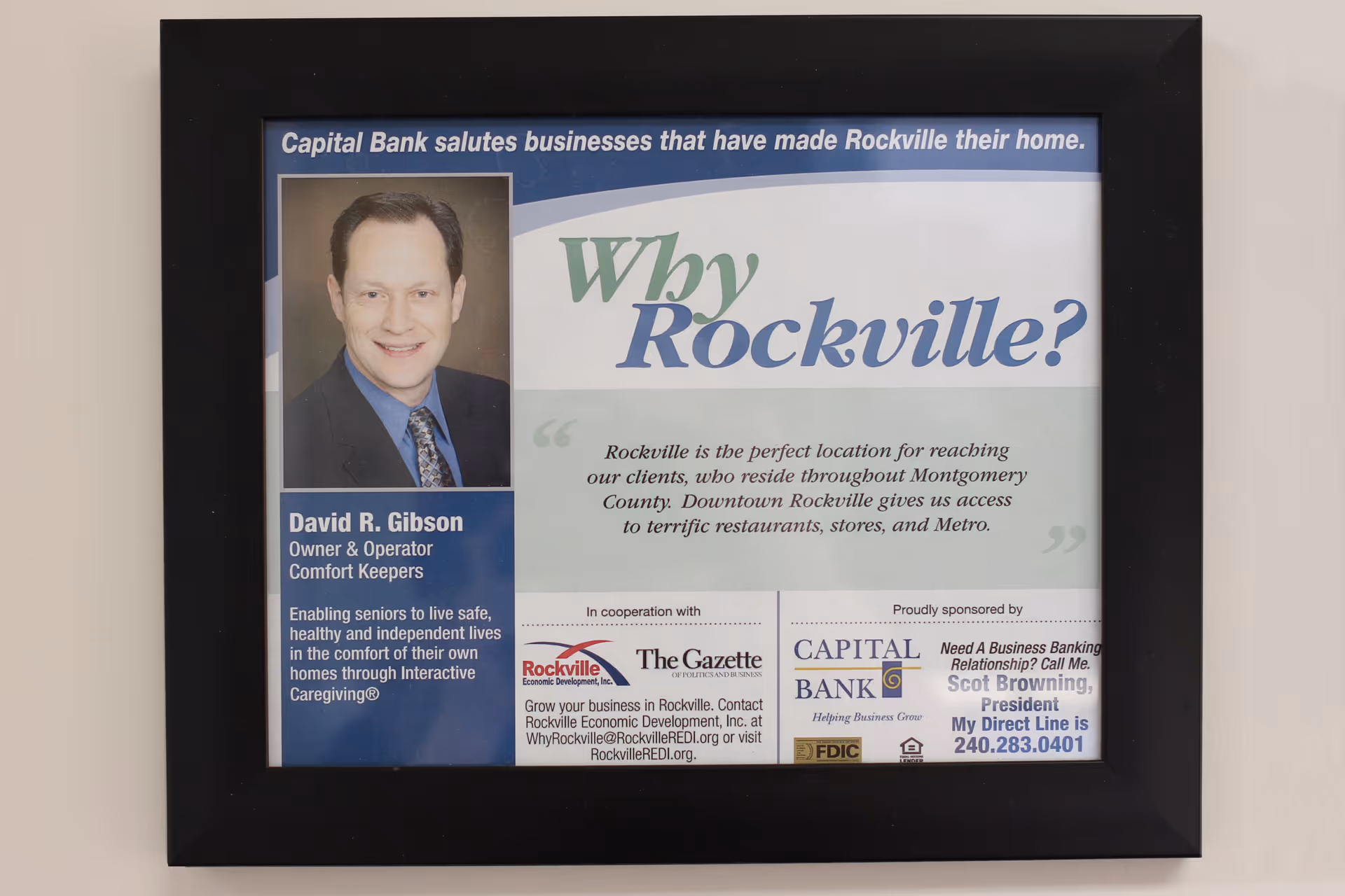 Framed poster on a wall at Comfort Keepers featuring a portrait and text.