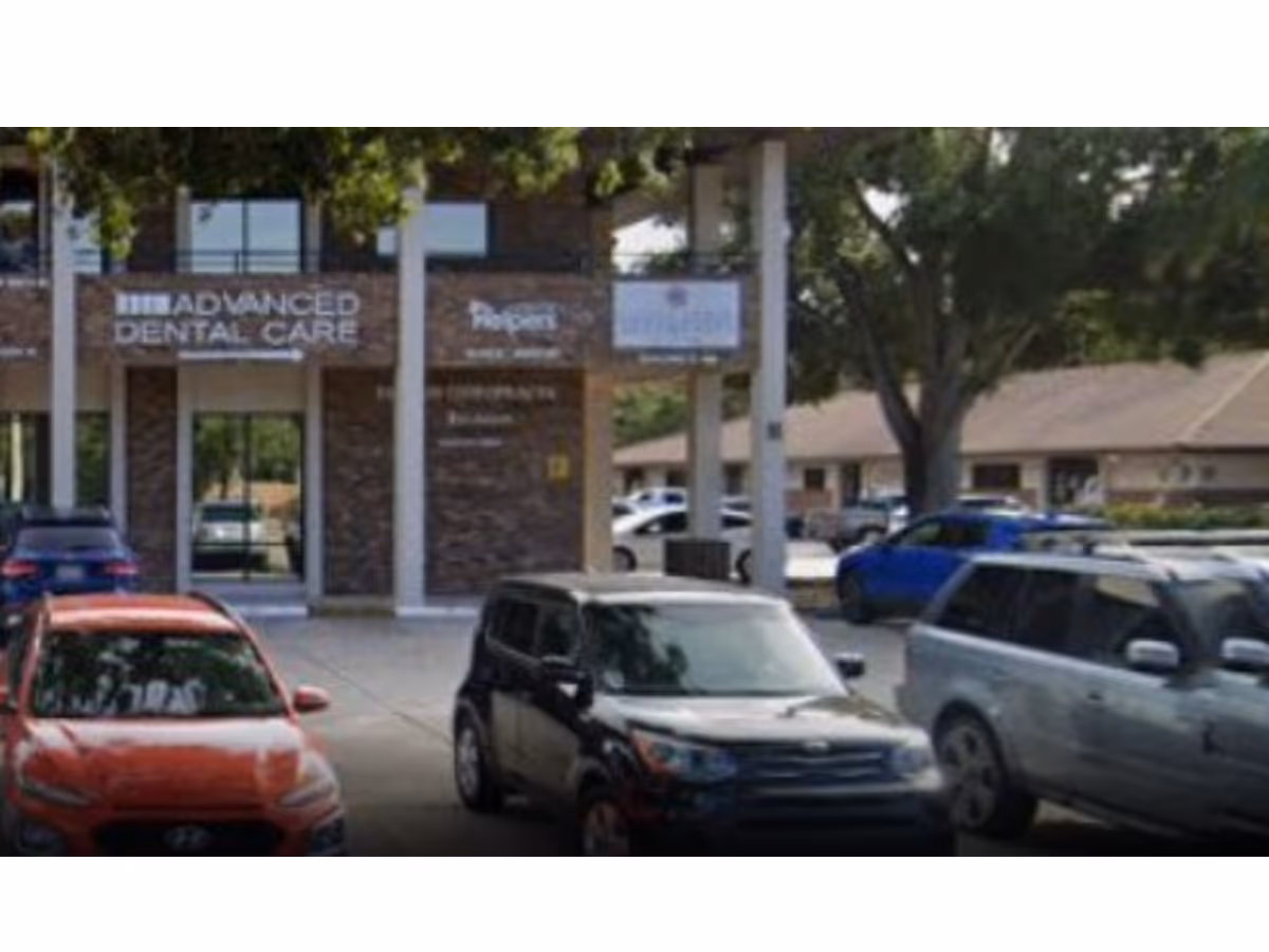 Parking lot in front of a brick building labeled Advanced Dental Care.