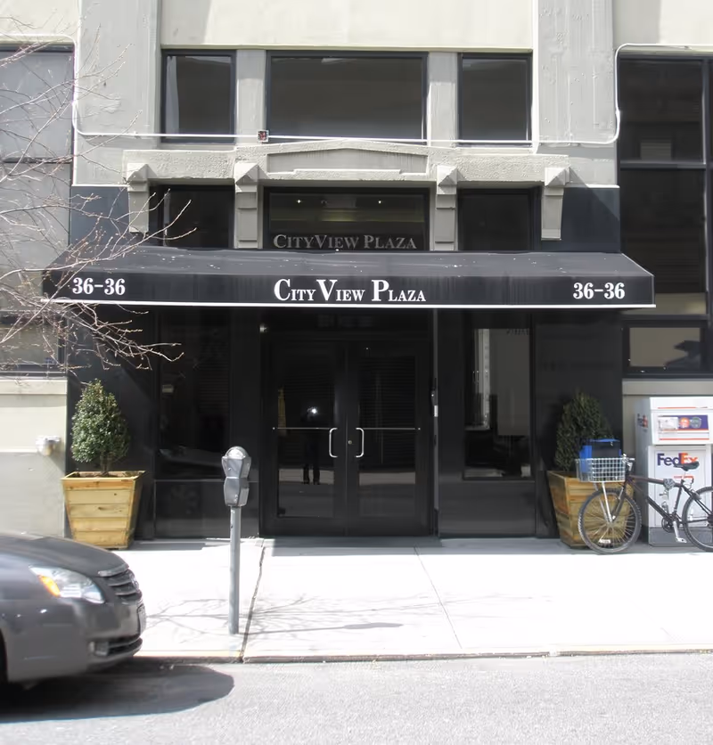 City View Plaza storefront with black awning and glass doors at street level.