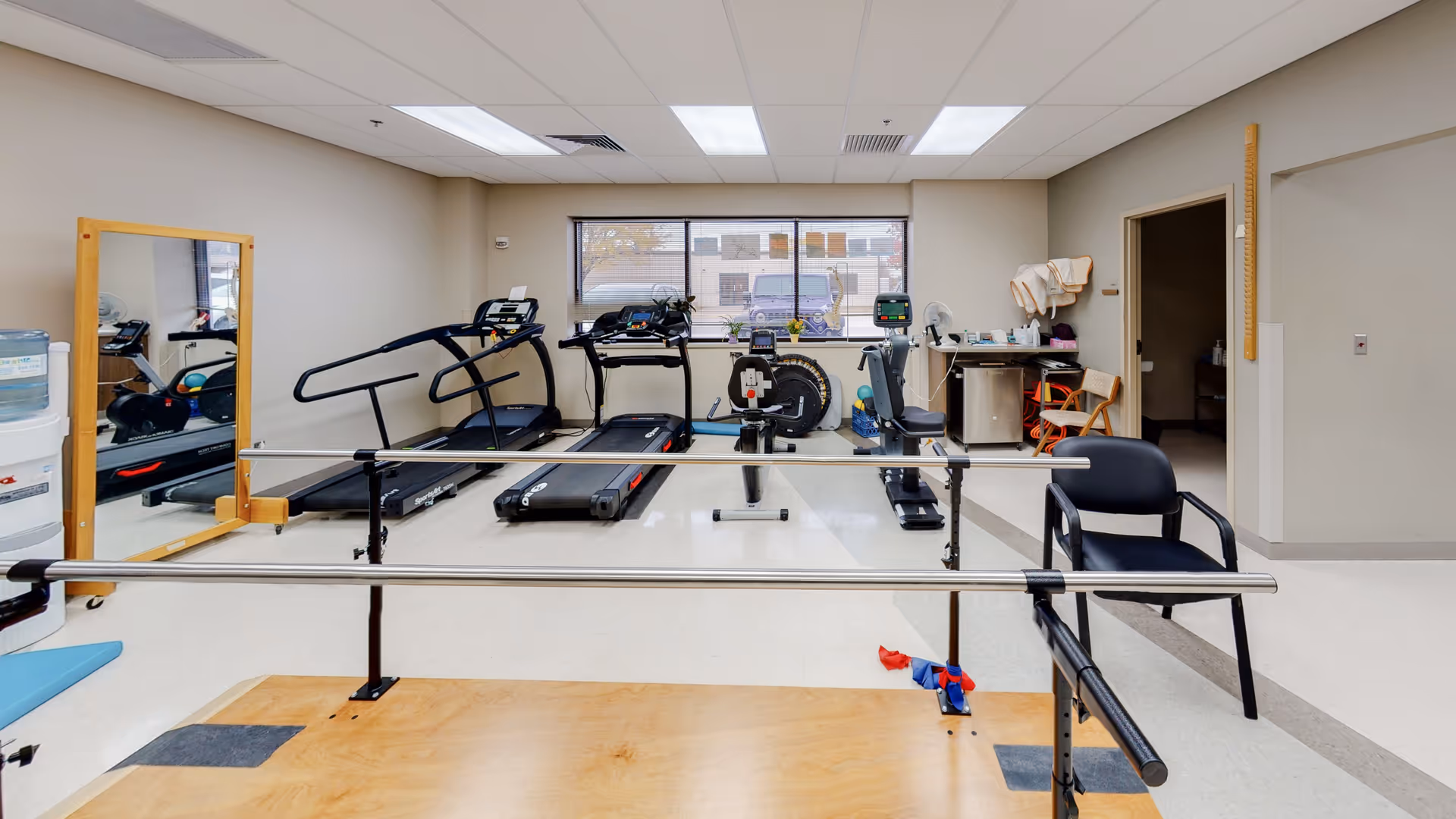 Indoor fitness room at Minneola District Hospital with treadmills and bikes.
