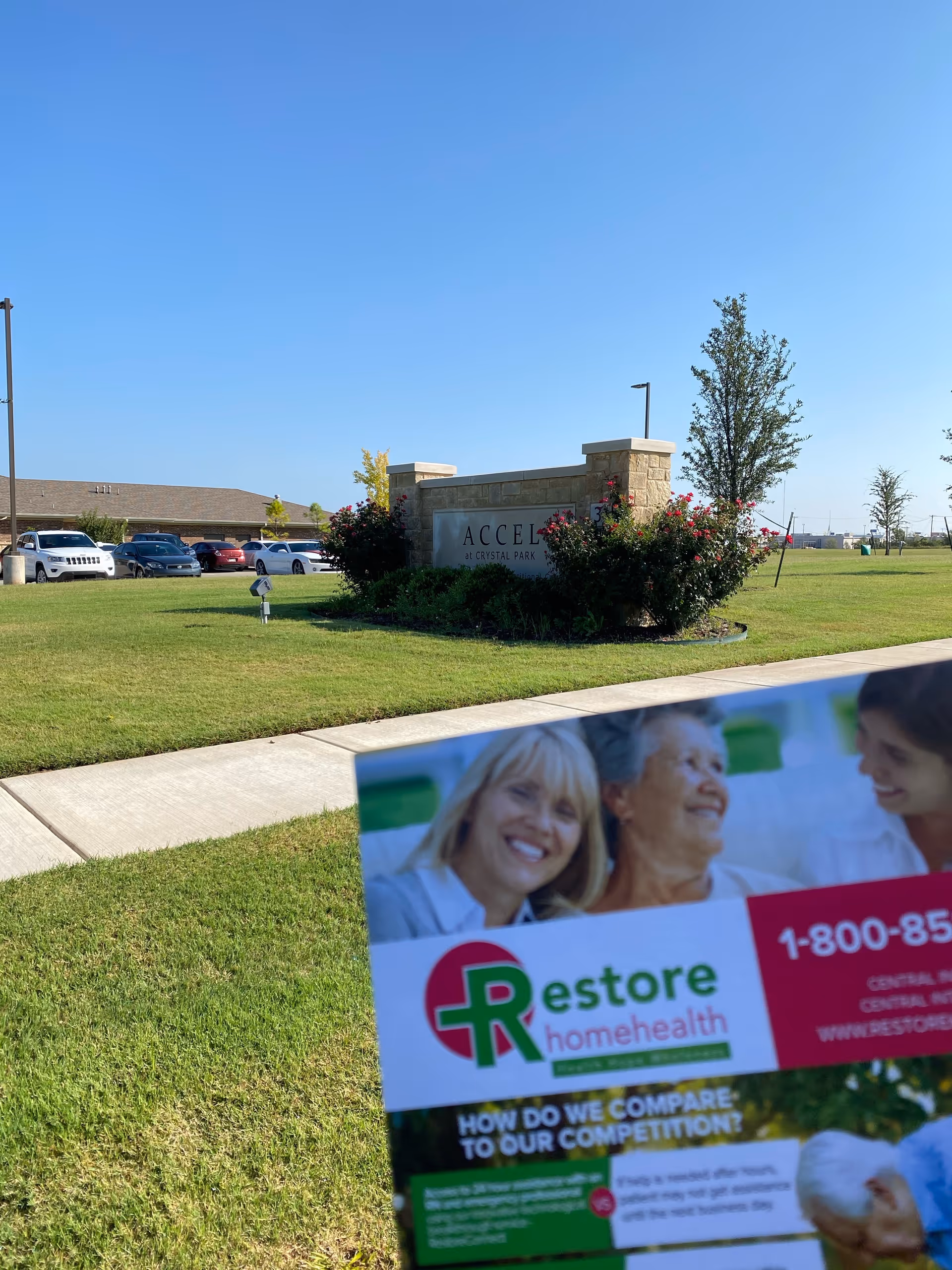 Exterior sign for Primary Clinic with landscaping and cars in a parking lot