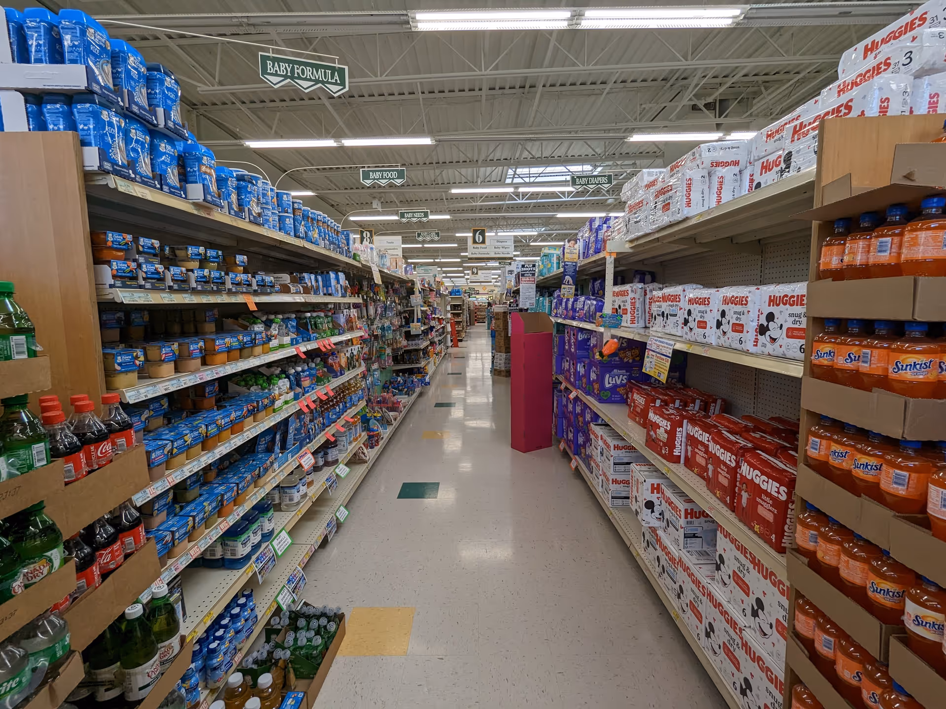 An interior Discount Drug Mart aisle stocked with baby formula and supplies.