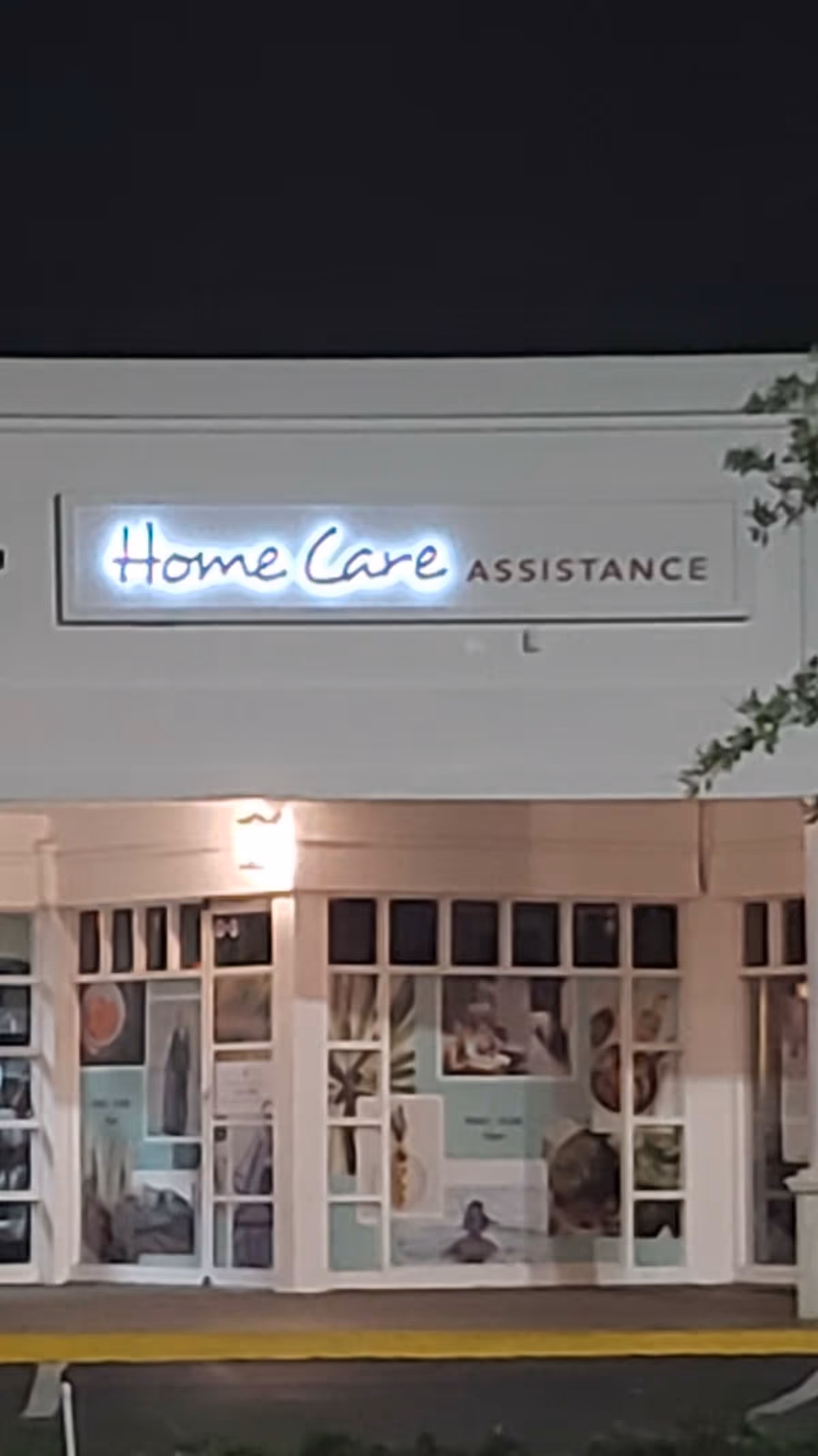 Night exterior of a senior home care storefront with illuminated 'Home Care' sign.