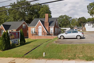 Exterior view of Comfort Keepers Home Care facility with a parked car.
