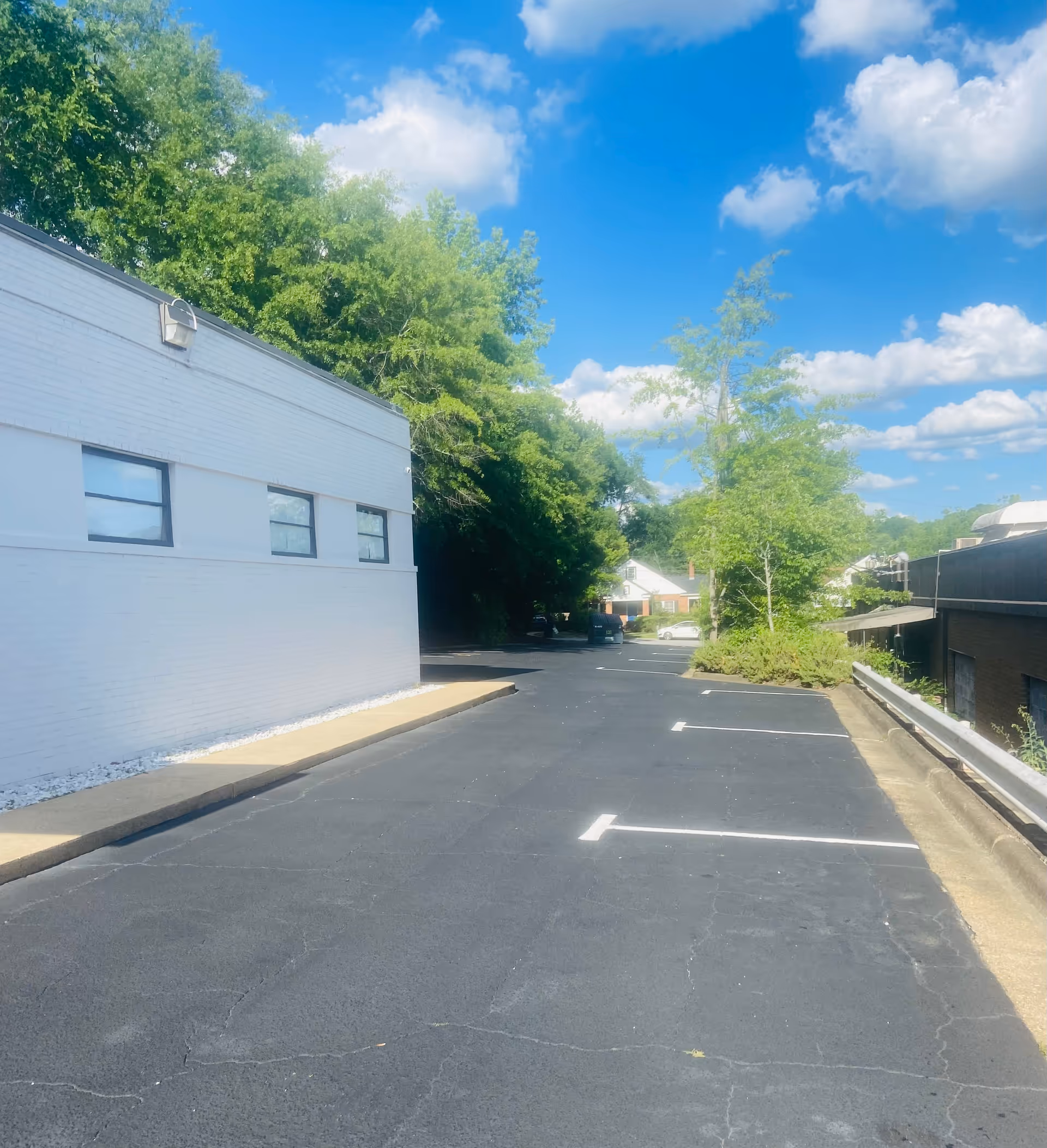Exterior view of Blue Skies Healthcare LLC building with a paved parking lot and trees.