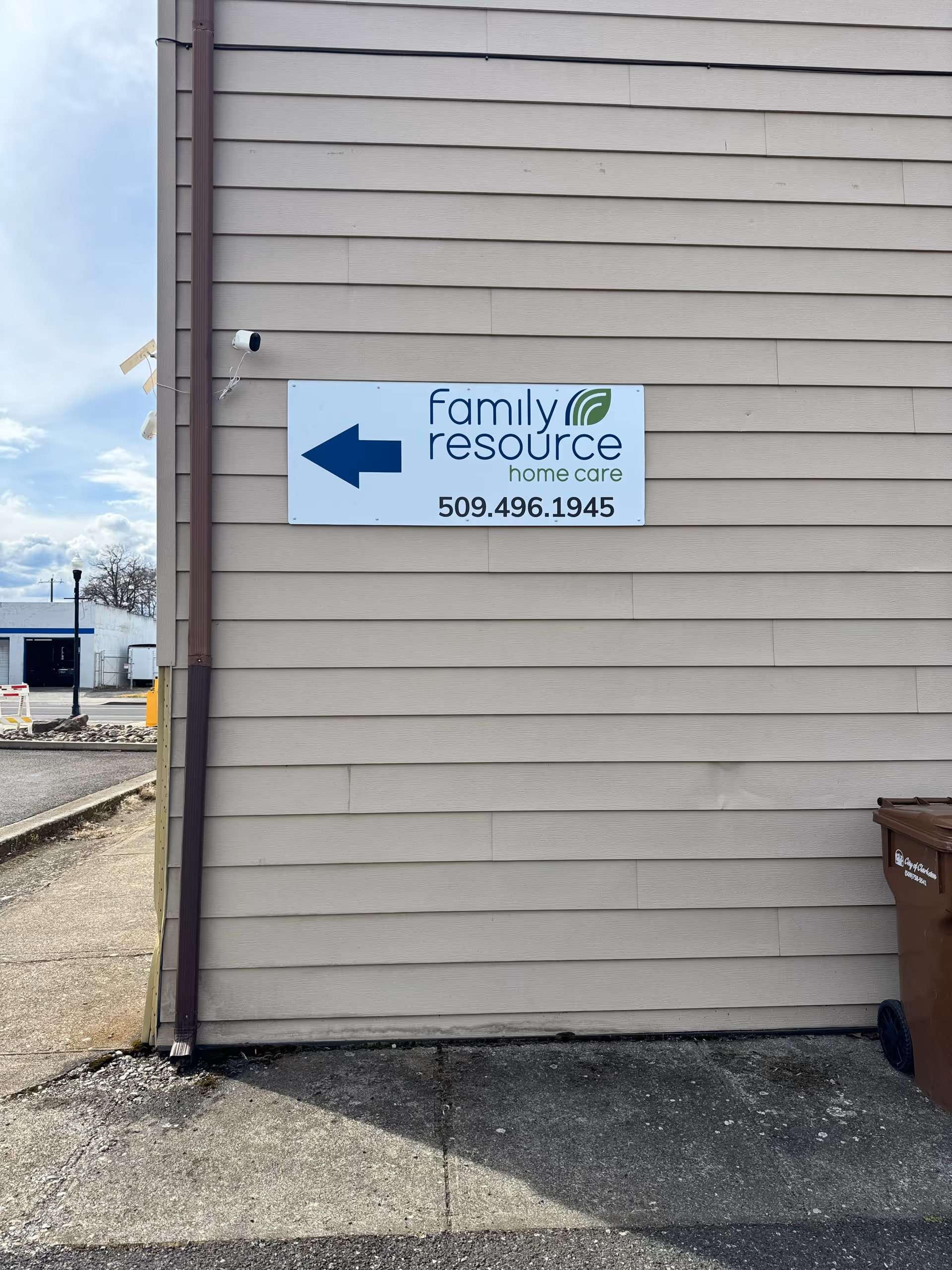 Exterior wall displaying a Family Resource Home Care sign with an arrow.