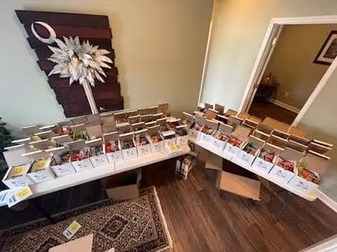 Interior common area with long tables displaying numerous pamphlet boxes and decorative wall art.