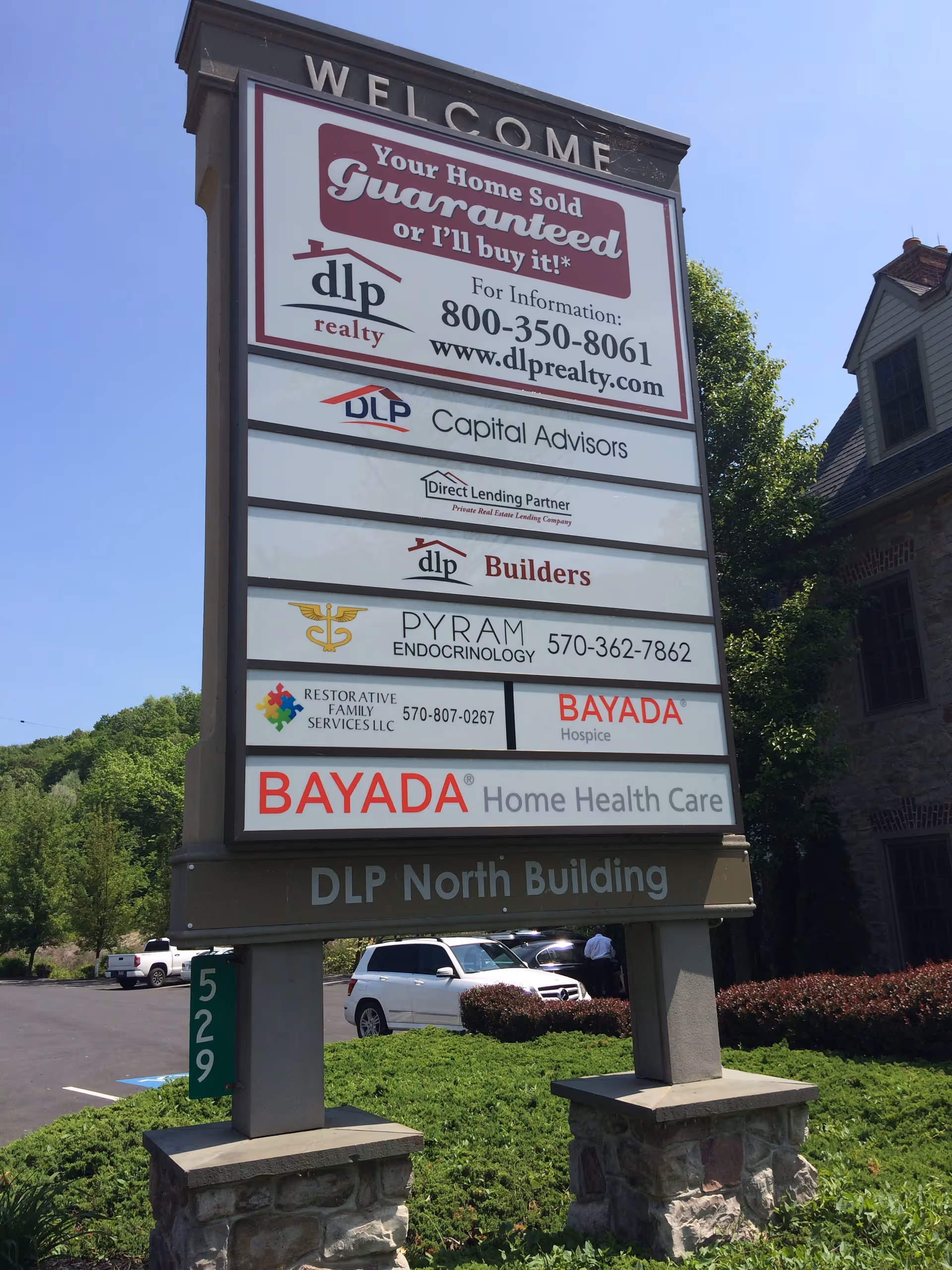 Tall outdoor signboard with BAYADA Hospice and other logos.