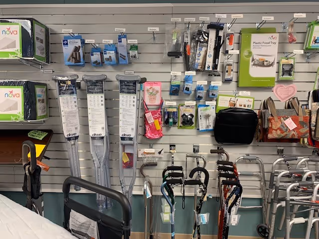 Indoor display wall of mobility aids and accessories in a retail showroom.