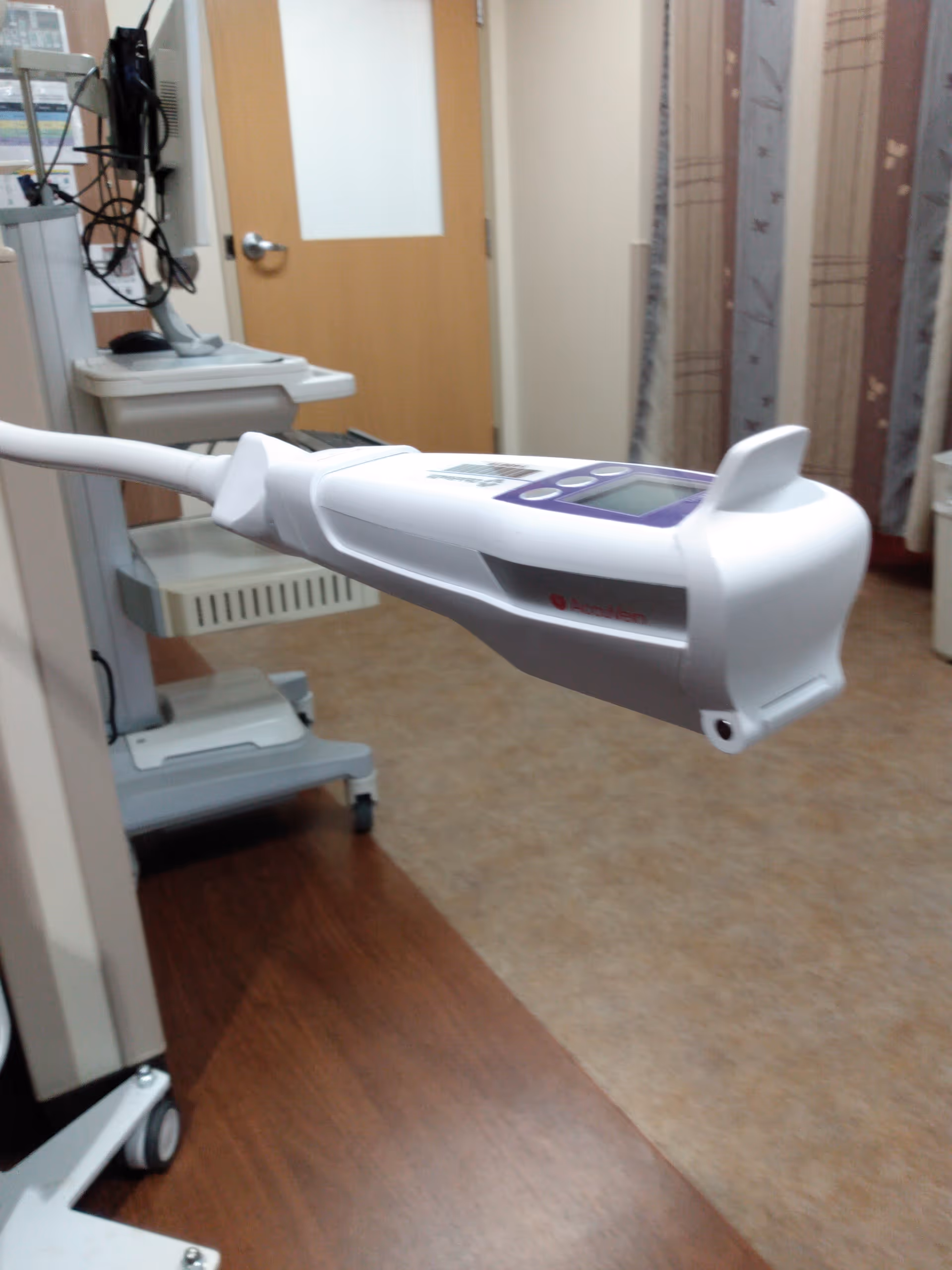 Infusion pump on a stand in a clinical infusion room.