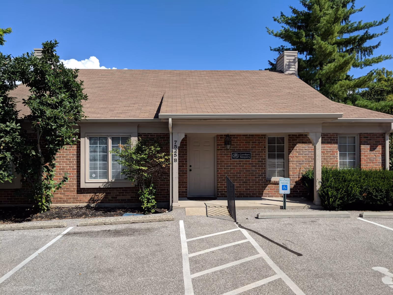 Brick senior living facility front with handicap parking and a centered entrance.