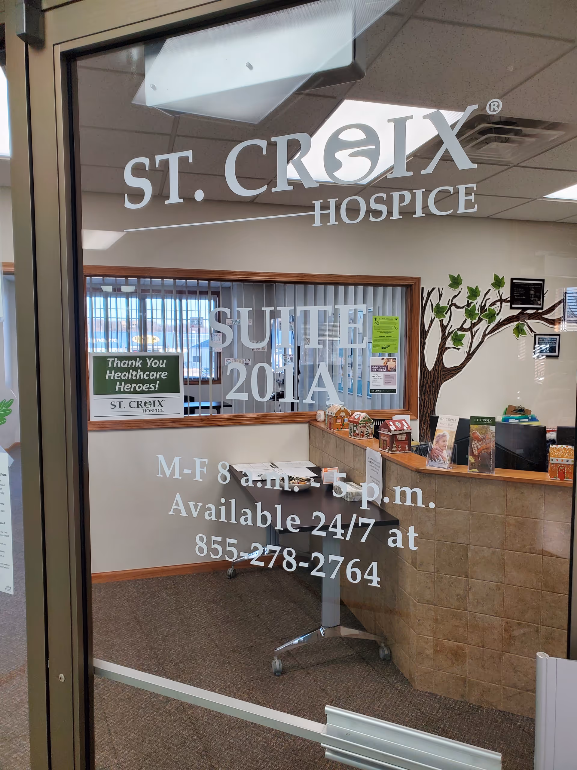 Entry lobby of St. Croix Hospice with reception desk and logo on glass.
