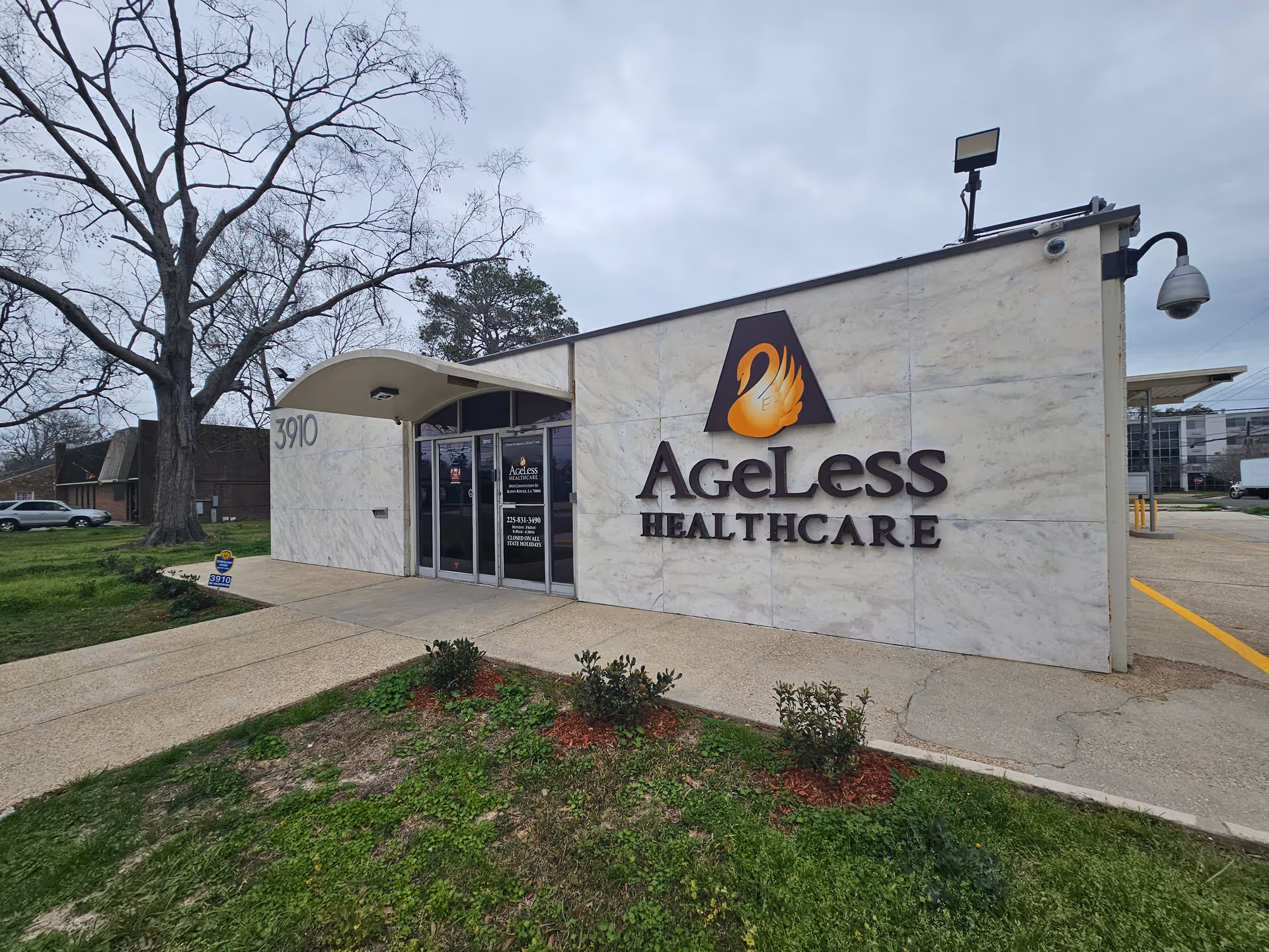 Exterior view of Ageless Healthcare building with its logo on a light marble facade.