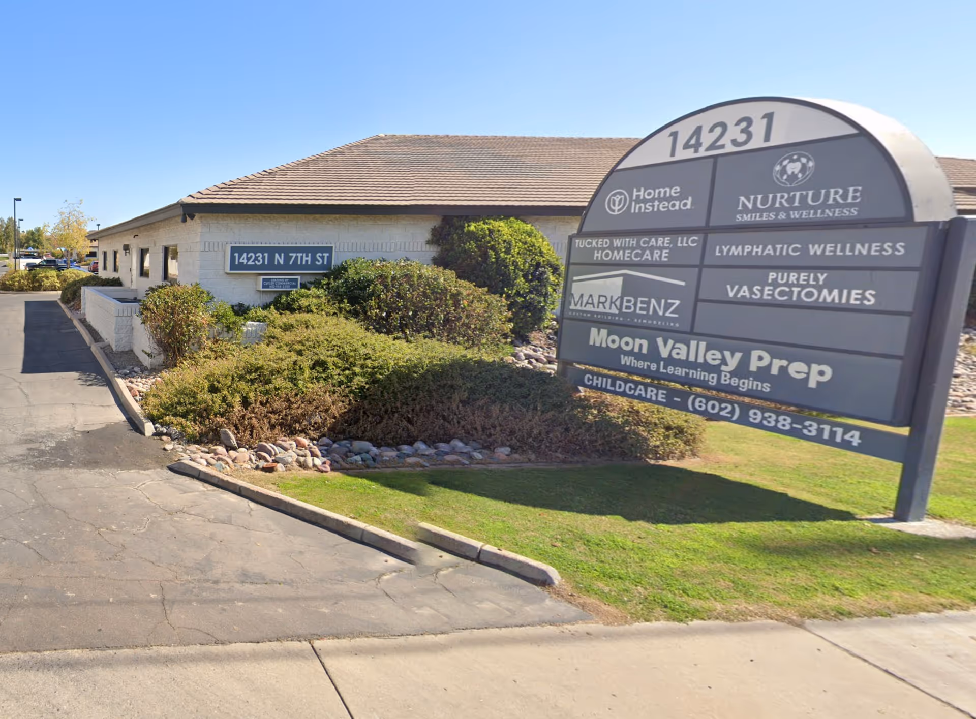 Exterior view of a single-story Home Instead facility with a large front sign.