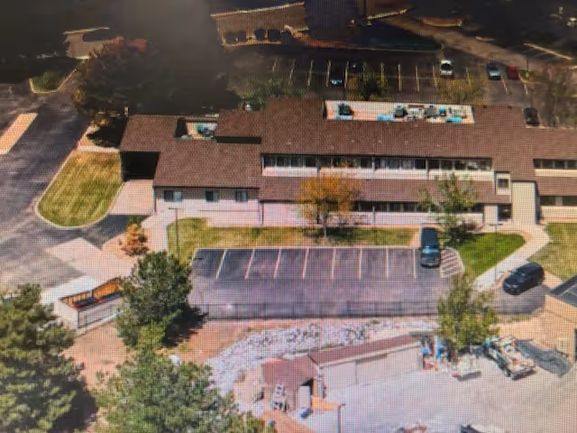 Aerial view of Comfort Keepers Home Care building with parking lot and grounds.