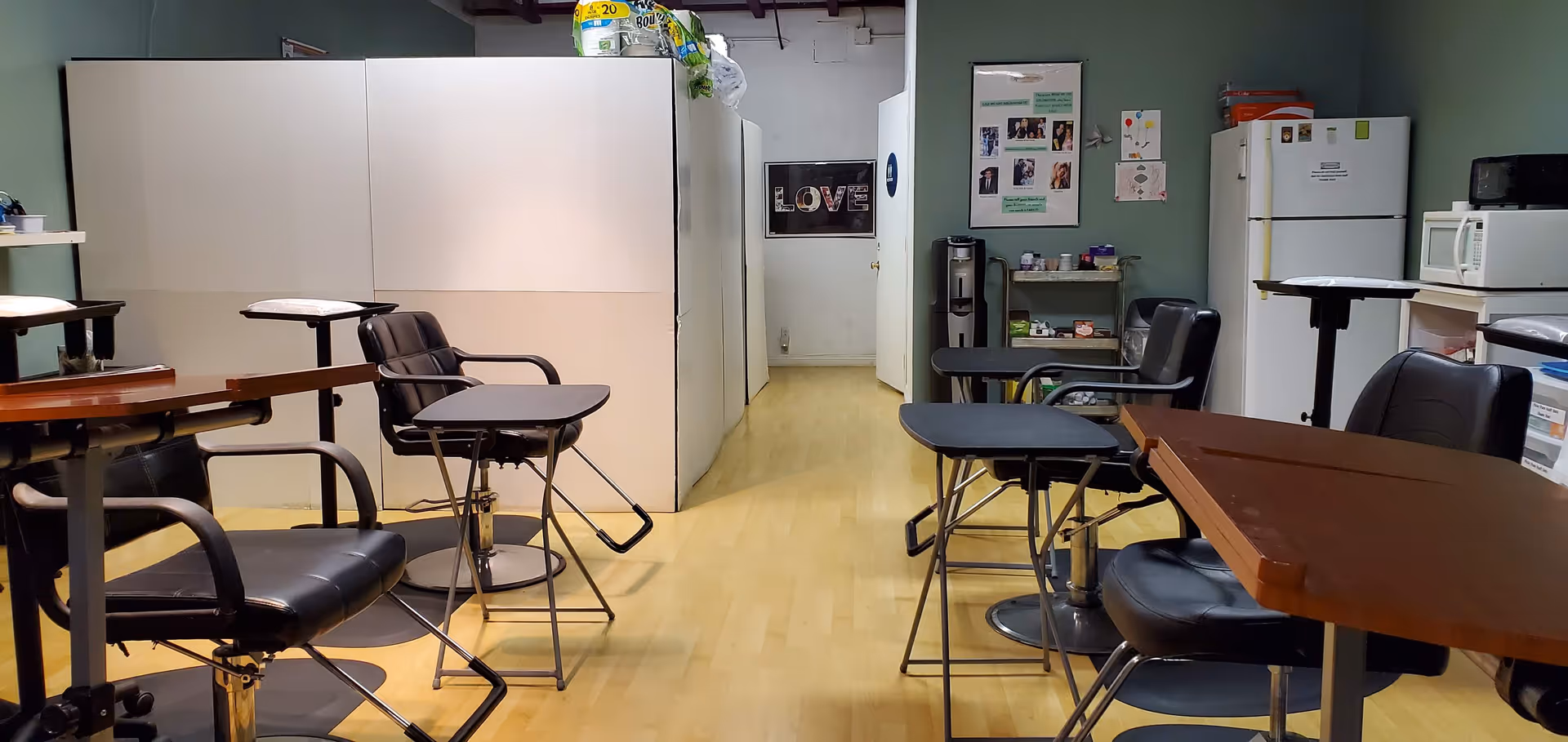 Indoor dining area with tables and chairs, and a kitchen visible in the background.