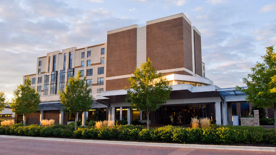 Exterior view of Northwestern Medicine OPIC at Palos Hospital: brick building, trees, and glass entrance.