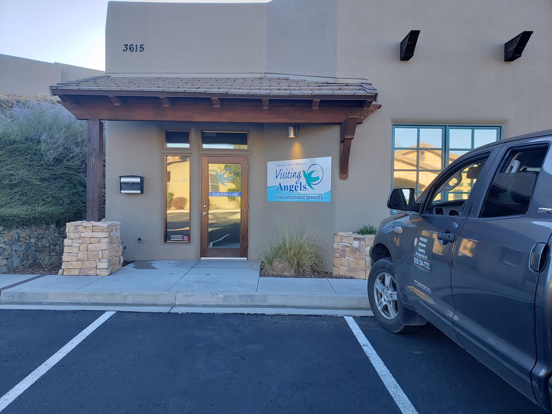 Exterior view of Visiting Angels Senior Home Care entrance with a vehicle parked outside.