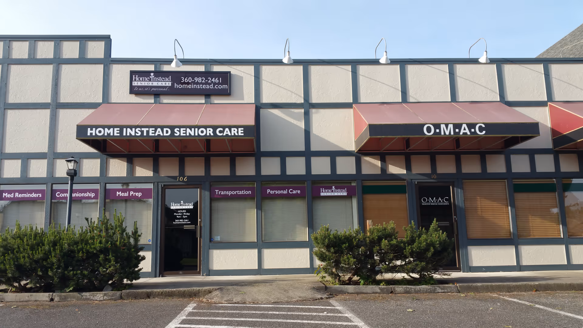 Facade of a storefront senior-care building with Home Instead and O-M-A-C signage.