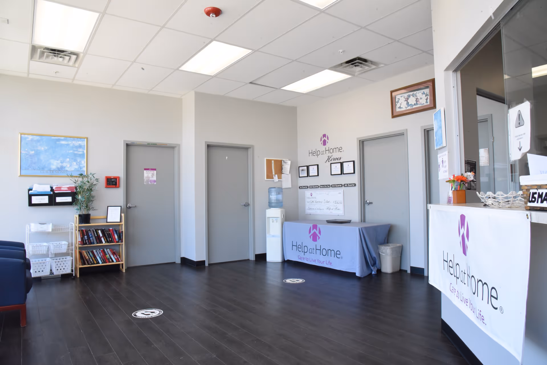 Bright lobby area with Help at Home branding, doors, and seating.