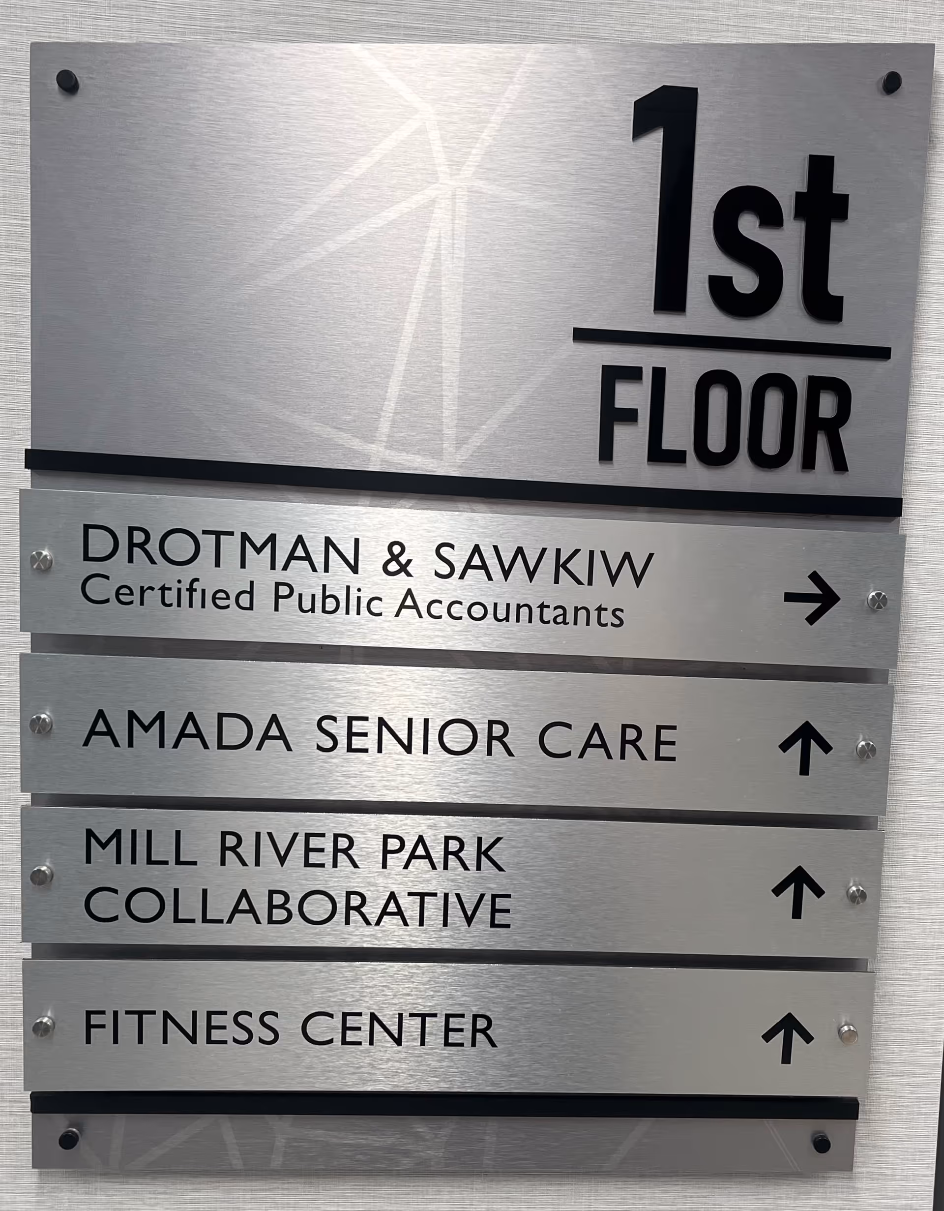 Interior directory sign on the wall listing Amada Senior Care and amenities.