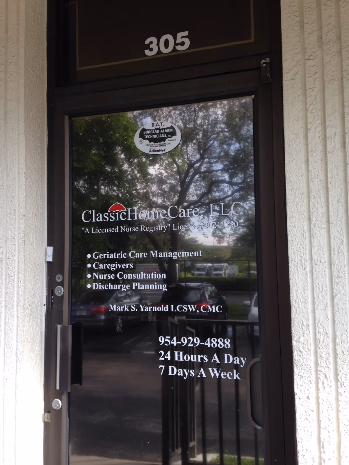 Glass entrance door displaying Classic HomeCare LLC signage and the number 305 above.