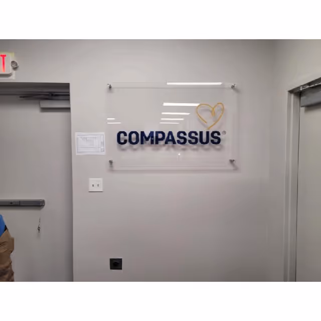 Interior hallway featuring a Compassus sign on the wall.
