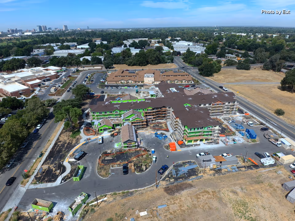 Aerial view of a large construction site with a multi-building complex under development.