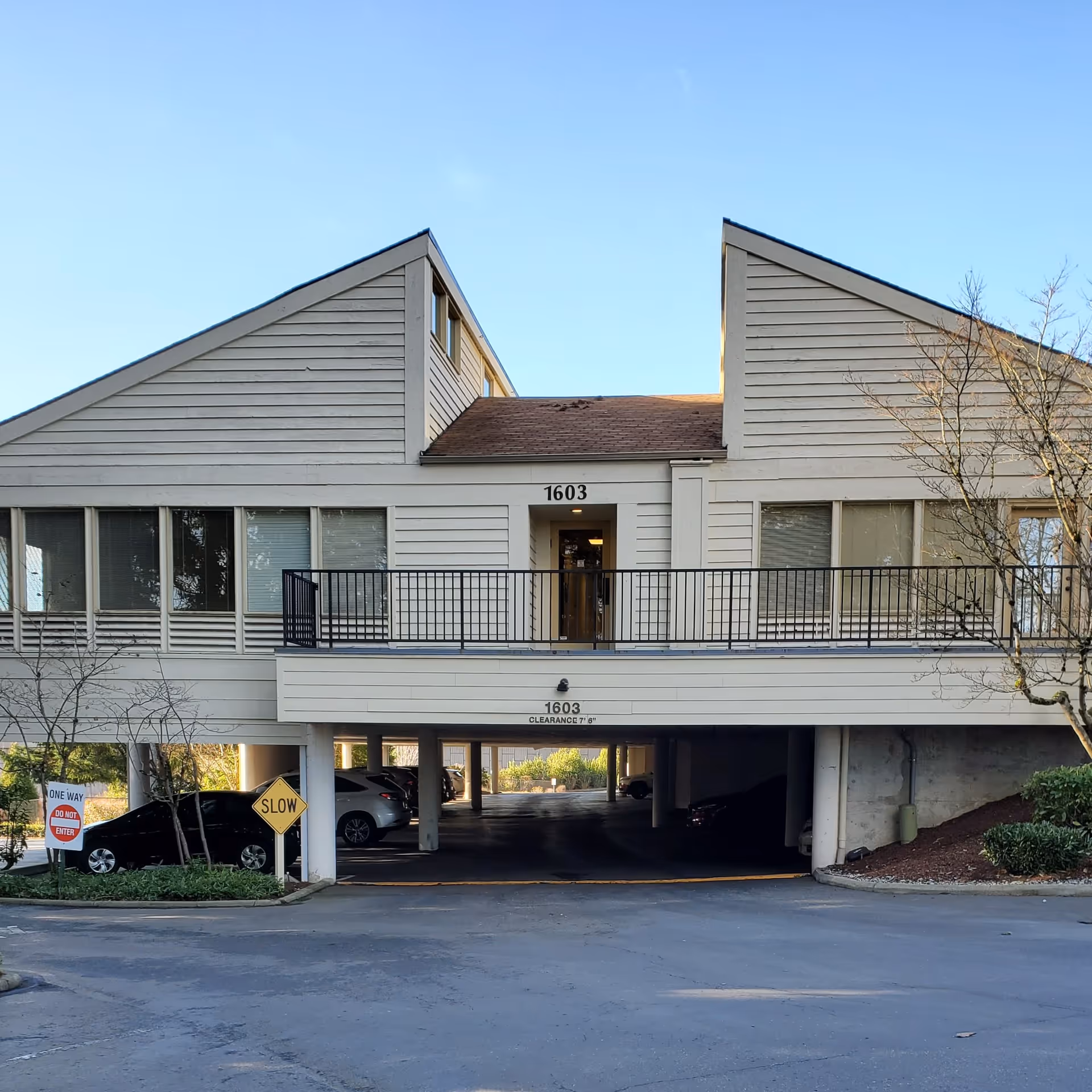 Front view of a two-story senior living building with parking underneath.