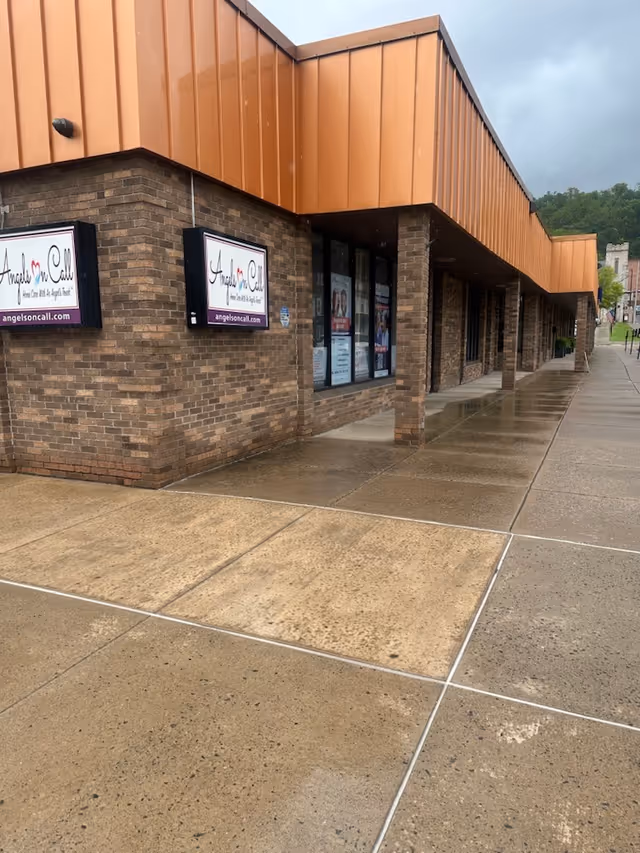 Exterior view of Angels On Call Home Care storefront with brick walls and sidewalk.