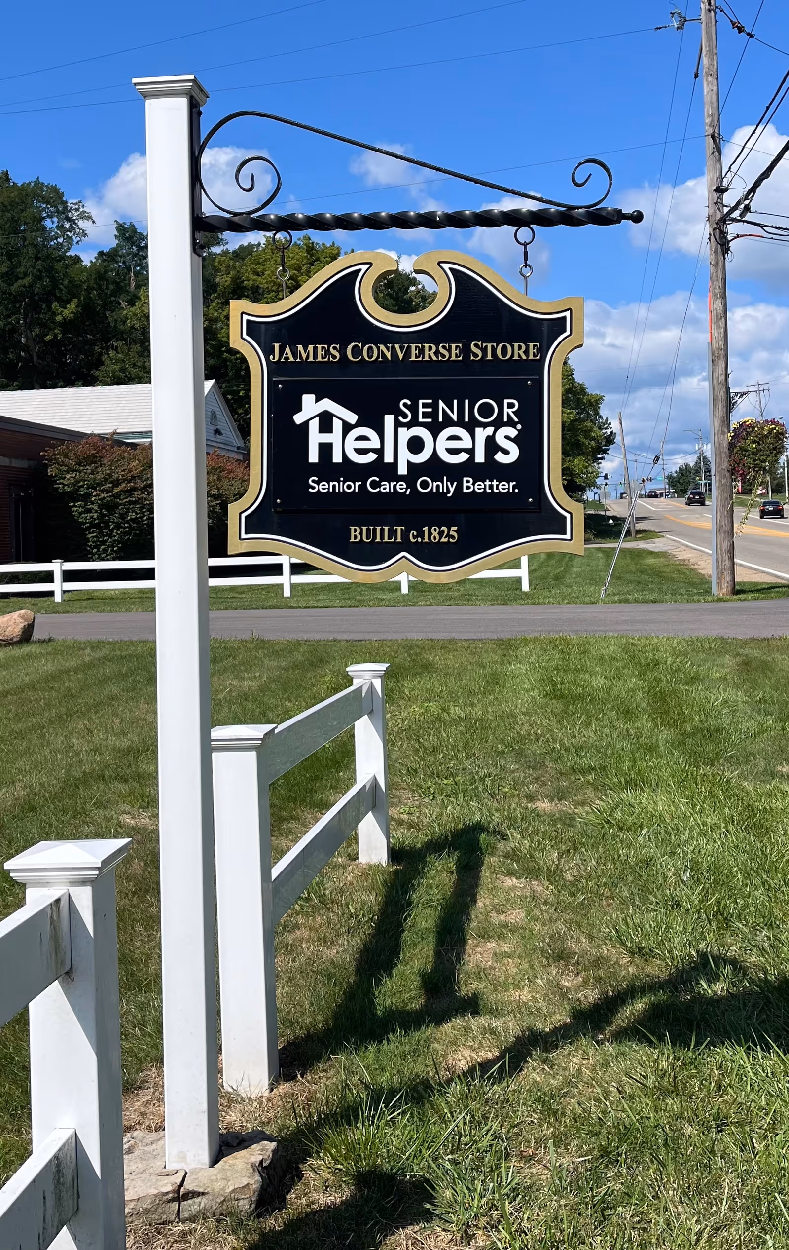 Outdoor sign for James Converse Store and Senior Helpers Senior Care along a road.