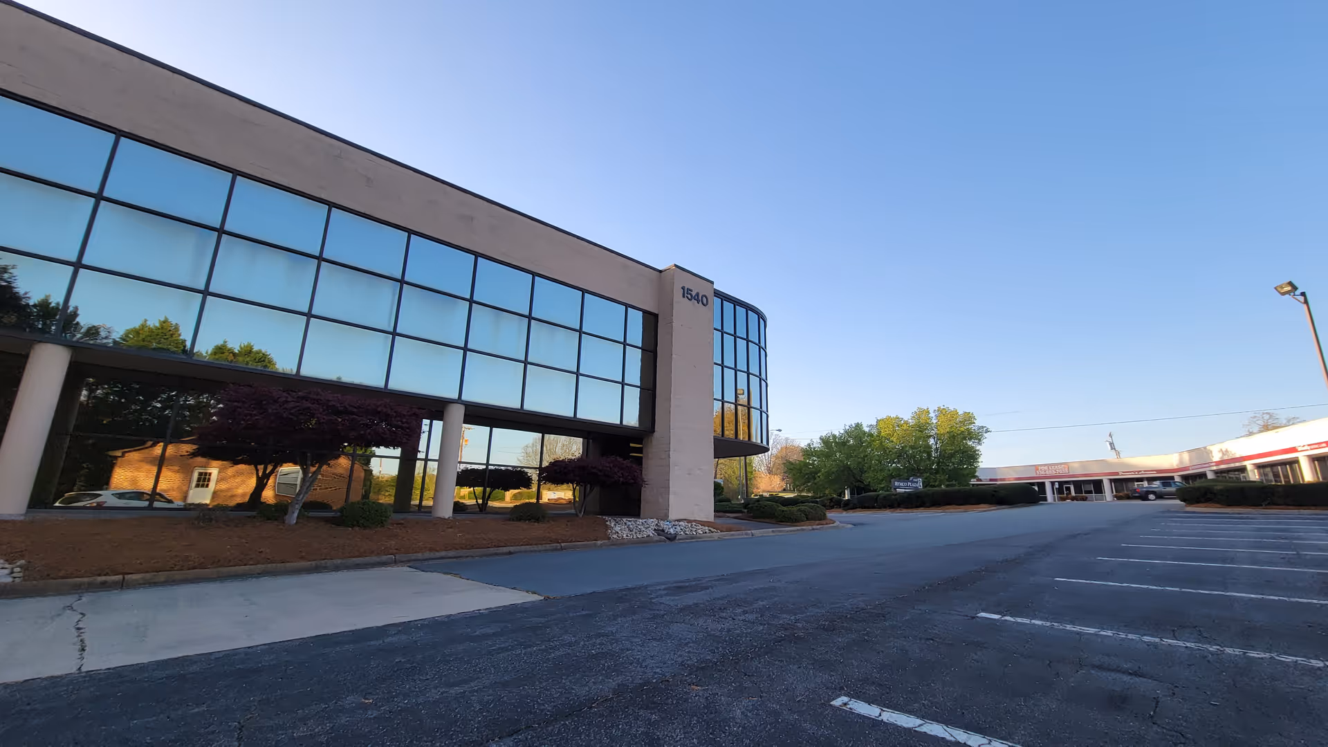Visiting Angels building with large glass windows and a spacious parking lot.