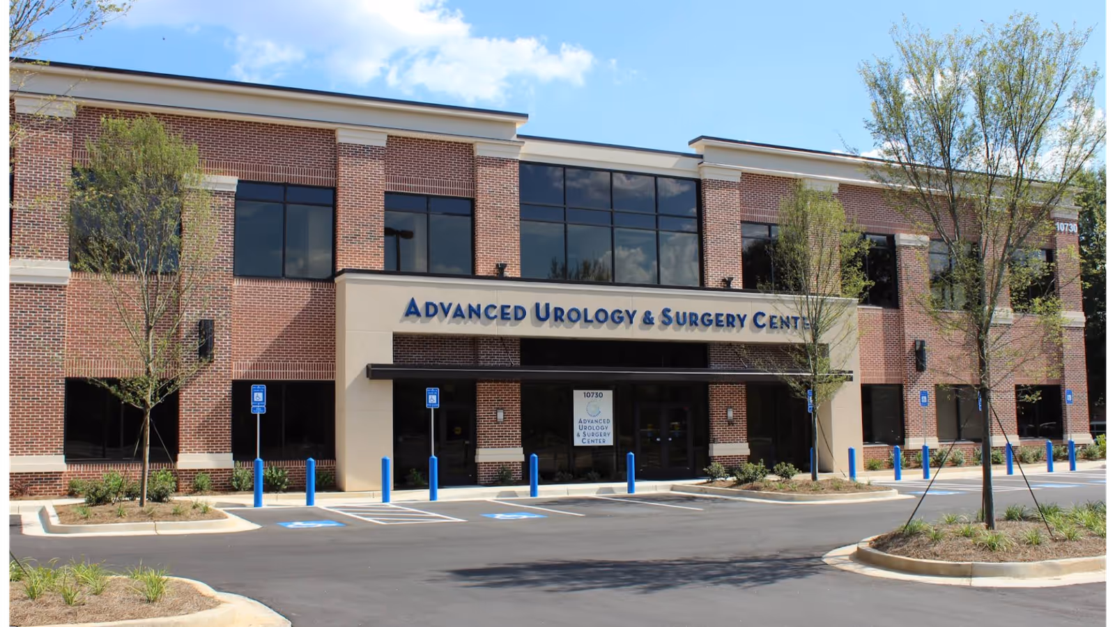 Brick medical office building with Advanced Urology signage and parking in front.