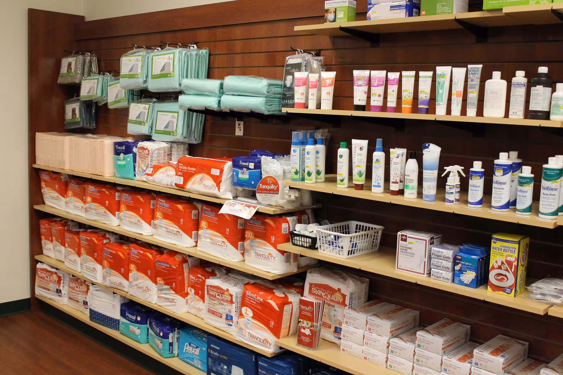 A well-stocked supply room in a senior living facility with shelves of toiletries.