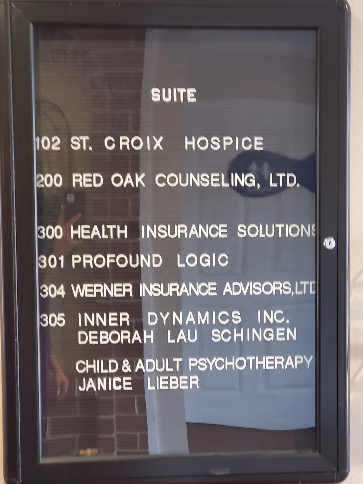 Interior glass sign panel listing suites and businesses including St. Croix Hospice.