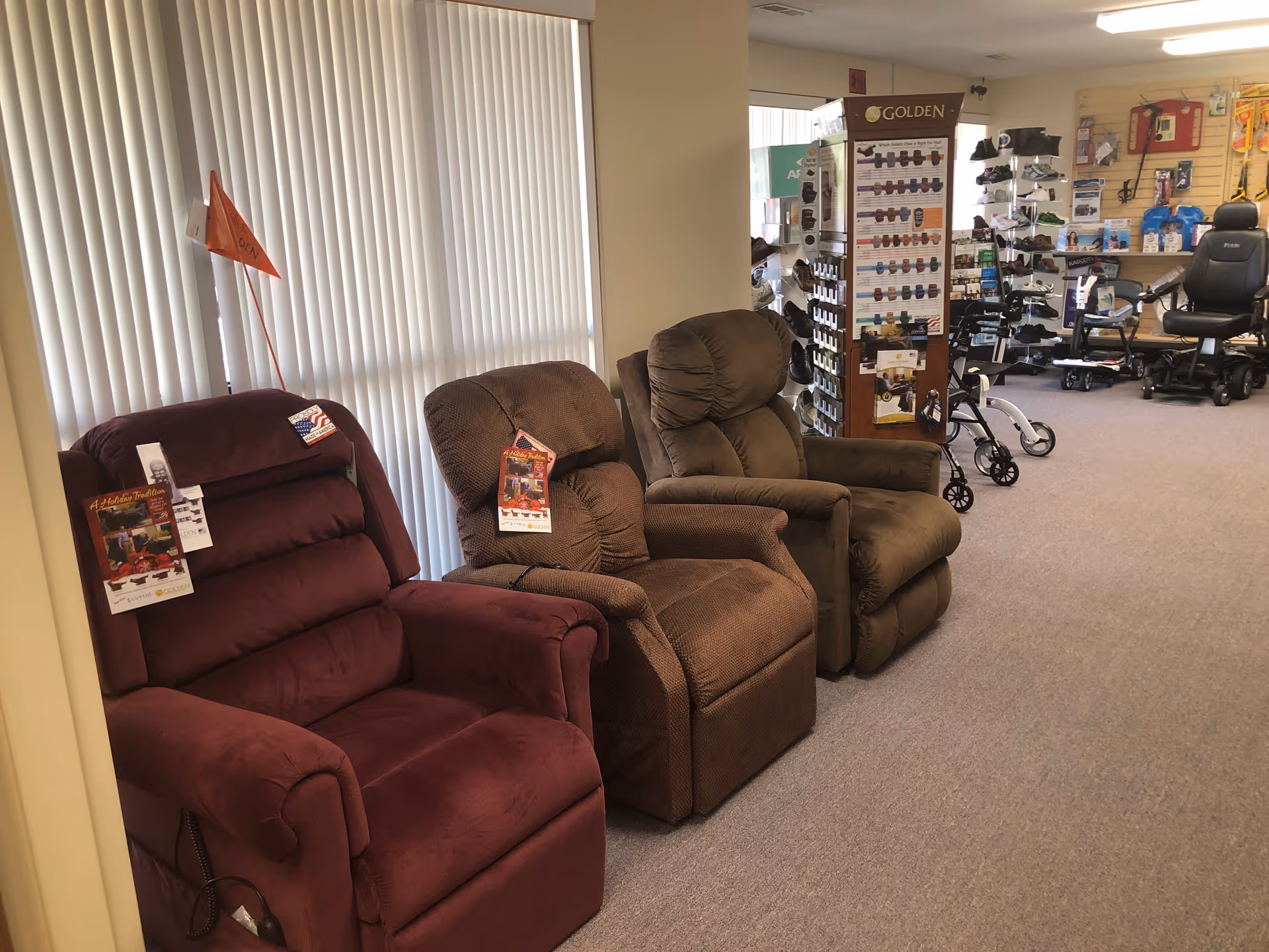 Rows of recliner chairs in a medical supply showroom, with blinds and product displays in background